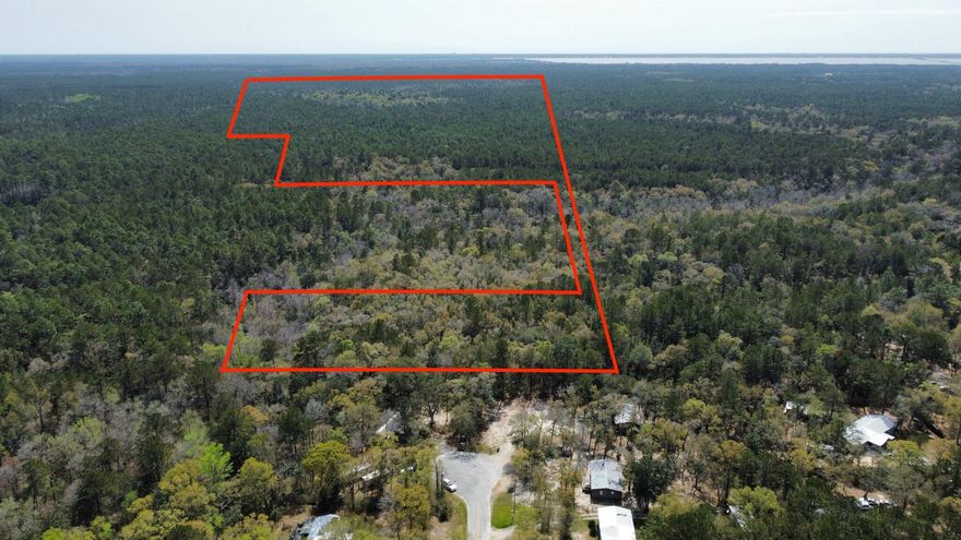 Discover the endless possibilities with this spacious +/-12-acre parcel in Freeport, offering the ideal location to build your dream home, create a private retreat, or even develop two separate residences. With no restrictive zoning or HOA, this property provides the flexibility to bring your vision to life, whether you're planning a family estate, a custom home, or a getaway property.Situated just off Hwy 331, this land is perfectly positioned between the beach and the bay, giving you the best of both worlds: serene privacy combined with easy access to everything you need. Within minutes, you'll find shopping, dining, and essential services like Publix and Starbucks, as well as quick routes to vibrant coastal communities and popular attractions.With ample space for multiple homesites, you can build a main residence, a guest house, or even a combination of both. Whether you're creating a peaceful haven for yourself or designing a multi-generational family property, this parcel offers the perfect canvas to make your dreams a reality.