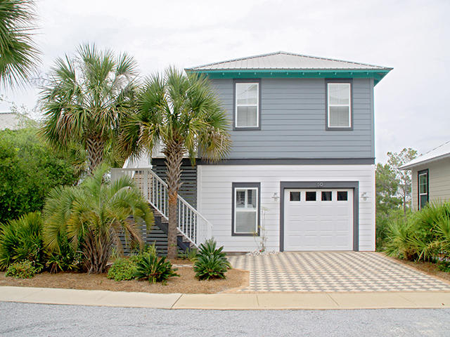 Room to grow. Beach Baby is positioned on the lot to expand for a main home. This is a rare opportunity to own in Seacrest Beach and receive rentals while building your main home. Beach Baby was a labor of love. Enter the second floor living space and you'll find yourself within airy cathedral ceilings. Your living and entertaining space becomes even more expanded with second floor wrap-around decks, surrounded by tall fanning palms and natural green space. Home is in immaculate condition.The casual galley kitchen with solid granite counter tops is fully equipped for all your cooking needs. The home has 2 bedrooms and lives way bigger than the actual sq. footage.A spiral staircase with a safety gate allows you to go directly downstairs.