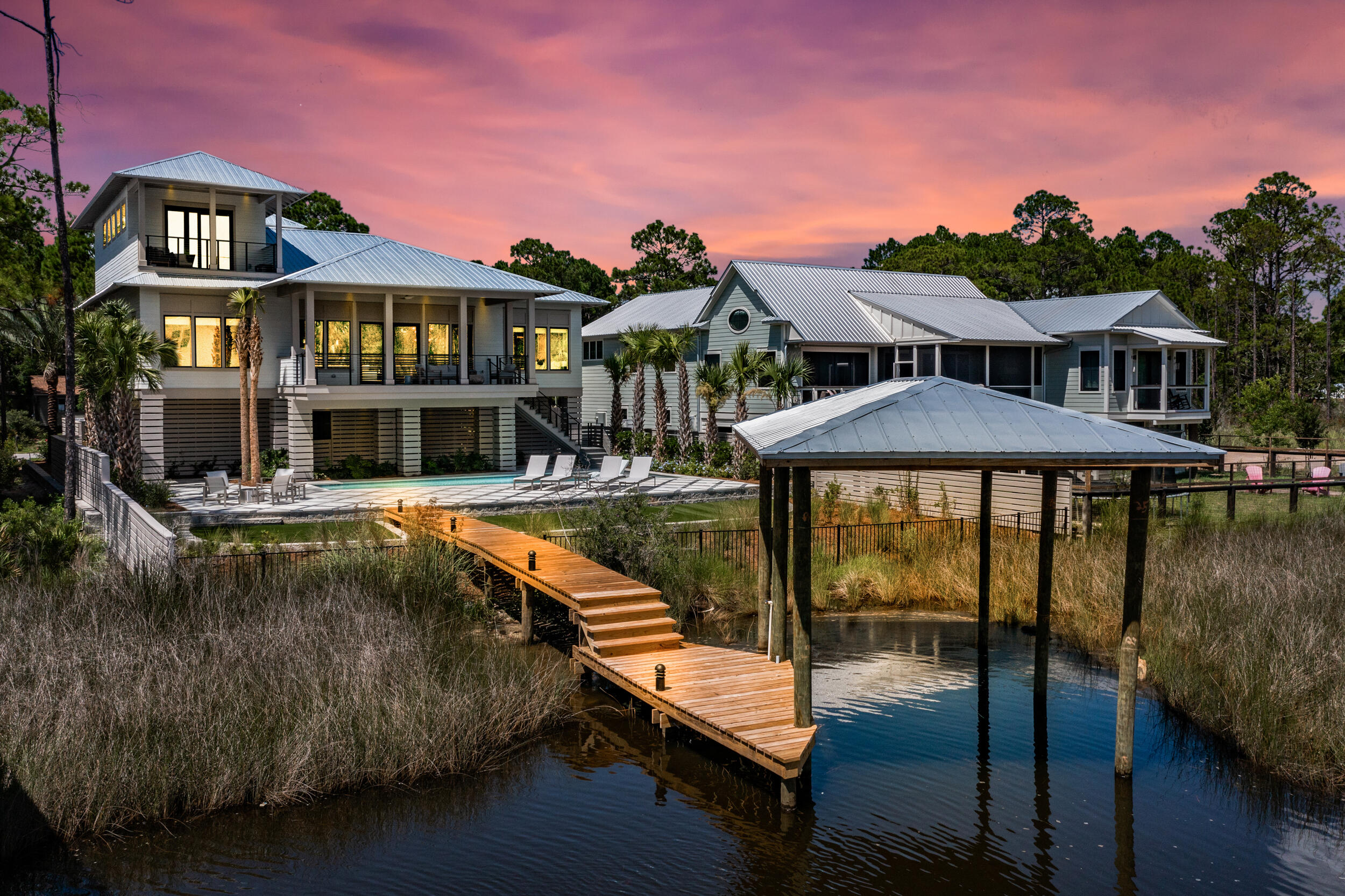 Sleek, modern architecture meets the otherworldly beauty of the Bayou in this brand-new custom home that would make for an excellent primary residence, second home or investment property. Perched at the water's edge, this boaters' paradise features a private dock that makes living on the water an everyday adventure, a refreshing pool relaxes cares away, and wide open views create the backdrop to an extraordinary life. Interiors offer striking finishes, with an open concept living room featuring wood floors, stained wood ceilings, breathtaking bayou views, and a large covered balcony with a built-in grill. The kitchen is stunning, with an oversized island that offers bar seating, and a place to gather with good company to enjoy impressive views.