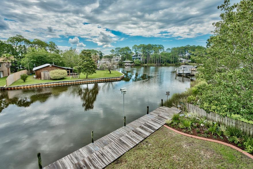 An amazing opportunity to own a waterfront home in Santa Rosa Beach for under $500,000! This lovely dwelling is a boater's paradise boasting 120 feet of private water frontage with seawall, deep water access, and a 12,000 lb boat lift and private dock. This one owner, custom built home is just a 5 minute boat ride to Baytowne Wharf and a 15 minute ride by boat to Crab Island. Each room of this coastal home displays lovely water views of Buck Bayou while huge porches invite you to hours of relaxing and entertaining as the sun rises on your very own piece of paradise. Across the street is Sandestin preserve which will not be built on maintaining a fabulous view of the woods.  Inside this 3 bedroom 2 1/2 bath home, freshly painted living spaces and new hardwood flooring greet you upon entry.  The gathering area is open an airy and flows effortlessly into the dining room.  A spacious chef's kitchen featuring granite countertops, new stainless steel appliances, and a breakfast bar with plenty of seating for your guests makes cooking and preparing meals a pleasure.  The master bedroom is just off the main living area featuring a master bathroom with garden tub, double vanities and granite counter tops.  Parking is no problem with a 2 car garage, expansive driveway and an additional parking pad to accommodate your boat and your RV.  Close proximity to shopping and restaurants at Grand Boulevard, Sandestin, and Silver Sands Factory Outlets.  Living on the water has never been more accessible!  Make the dream of waterfront living your reality, today!