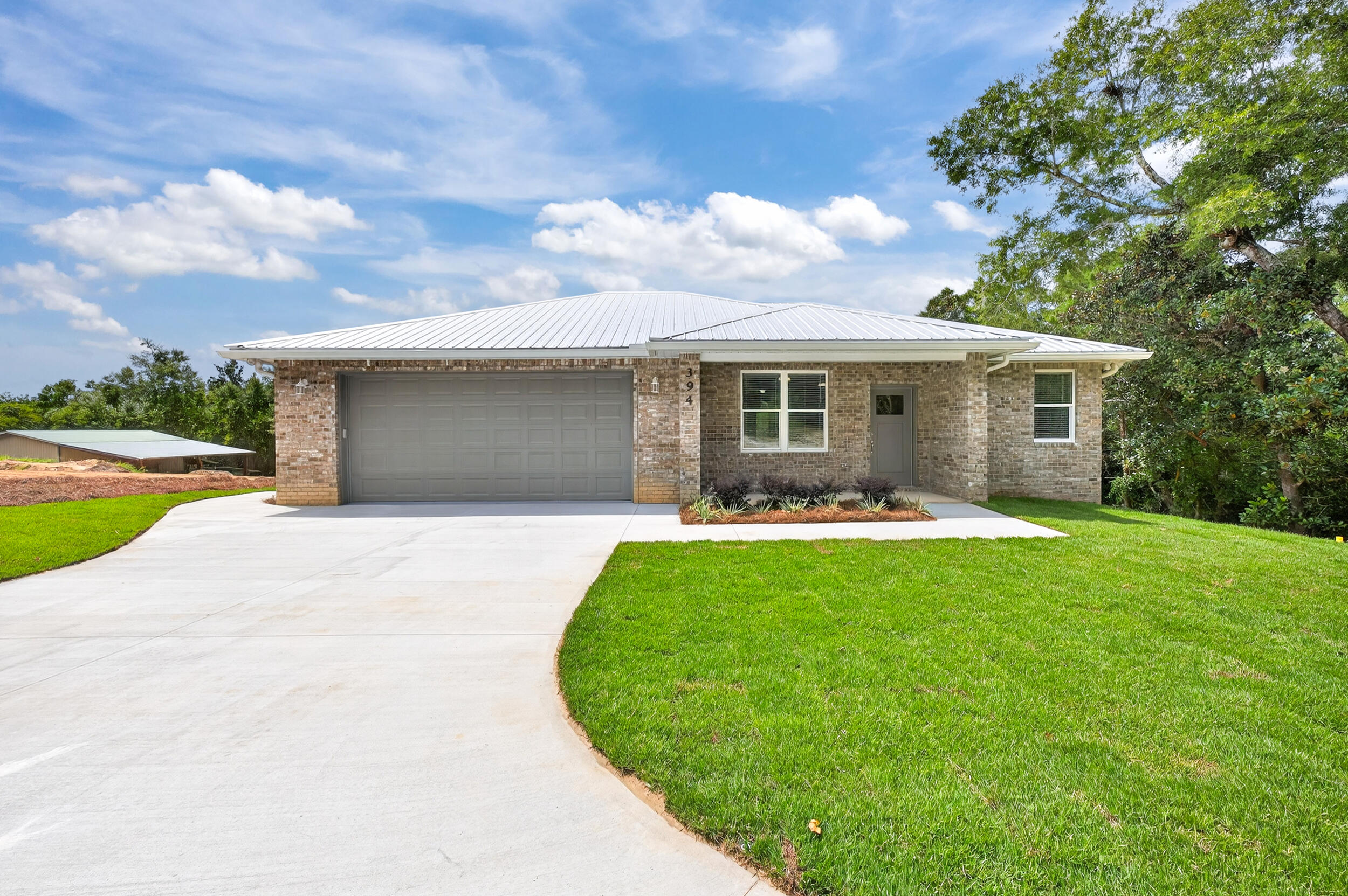 Discover your dream home in this stunning new construction residence perfectly positioned on a peaceful dead-end street in the heart of Niceville. This beautifully crafted 3-bedroom, 2-bathroom home features durable metal roofing and elegant brick siding, creating both curb appeal and long-lasting quality.Step inside to find soaring high ceilings with sophisticated crown molding throughout, complemented by beautiful luxury vinyl plank flooring in the main living areas. The thoughtfully designed split floor plan maximizes privacy while the open-concept kitchen becomes the heart of the home with crisp white shaker cabinets, stunning quartz countertops, and modern stainless steel appliances.The master suite serves as your personal retreat with an expansive walk-in closet and spa-like bathroom boasting a spacious vanity and luxurious tile walk-in shower with frameless glass doors. The convenient Jack and Jill bathroom design adds functionality for family living.
Outside, you'll enjoy a large, well-maintained yard with professional irrigation system, fully fenced for privacy, and an inviting back porch perfect for relaxation and entertaining. The spacious driveway leads to a conveniently oversized 24x24 2-car garage, completing this exceptional property.
Location couldn't be better - less than 1 mile to Turkey Creek Nature Walk for outdoor enthusiasts, just 5 miles to Eglin Air Force Base, and only 13 miles to the pristine beaches of Destin. This exceptional property combines modern comfort with practical living in one of Niceville's most desirable locations.