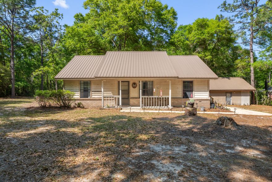 PRICE REDUCTION, Enjoy your own piece of paradise! Quaint 3-bedroom, 2-bath home on 2.38 acres with plenty of privacy and a peaceful, country feel. This home features a brick gas fireplace in the cozy living room. All bedrooms and bathrooms have new flooring, installed 01/2025. Durable metal roof only 4 years old. Rinnai tank less hot water heater installed in 2019 for endless hot water. Back yard has a spacious 20 x 20 workshop with a 4 yr old metal roof which is perfect for all your projects or extra storage. Enjoy the serenity of country living while still being near schools and shopping. The lush wooded back yard offers plenty of room to expand.