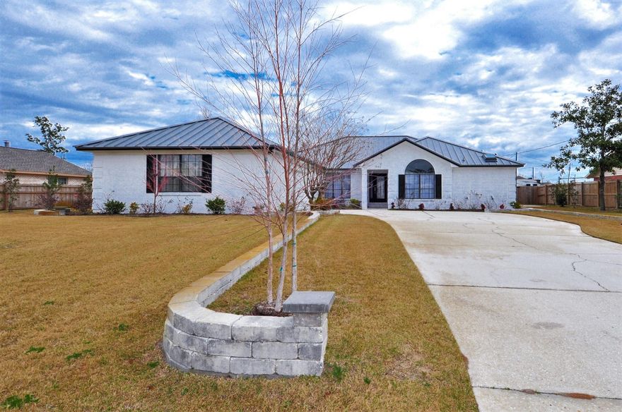 Custom designed home with fantastic split-bedroom floorplan! This 4BR/3BA home is in the Wildridge community of Lynn Haven and is practically brand new! The standing seam metal roof was installed in 2019, the AC in 2021. The layout includes a large great room with vaulted ceiling and double French doors that access the screened porch off the back of the home. The kitchen has solid-surface countertops and new refrigerator, Bosch dishwasher and microwave all stainless steel. There is a large breakfast nook with bay window, and a formal dining room. The Master Bedroom has two walk-in closets. You can also access the porch from the master suite and an additional bedroom on other side of the home. There are Jack and Jill bedrooms as well. The two-car garage has an adjoining workshop and houses  the Culligan water system. The entire backyard is privacy fenced and sellers say there is a plenty of room to add a pool. There is an automatic sprinkler system and there is an extra concrete pad ideal for parking a boat/jet skis. The home is on a cul-de-sac street so it's perfect for a family and you're convenient to schools, shopping, medical facilities and more! All info is approx and must be verified by Buyers if important.