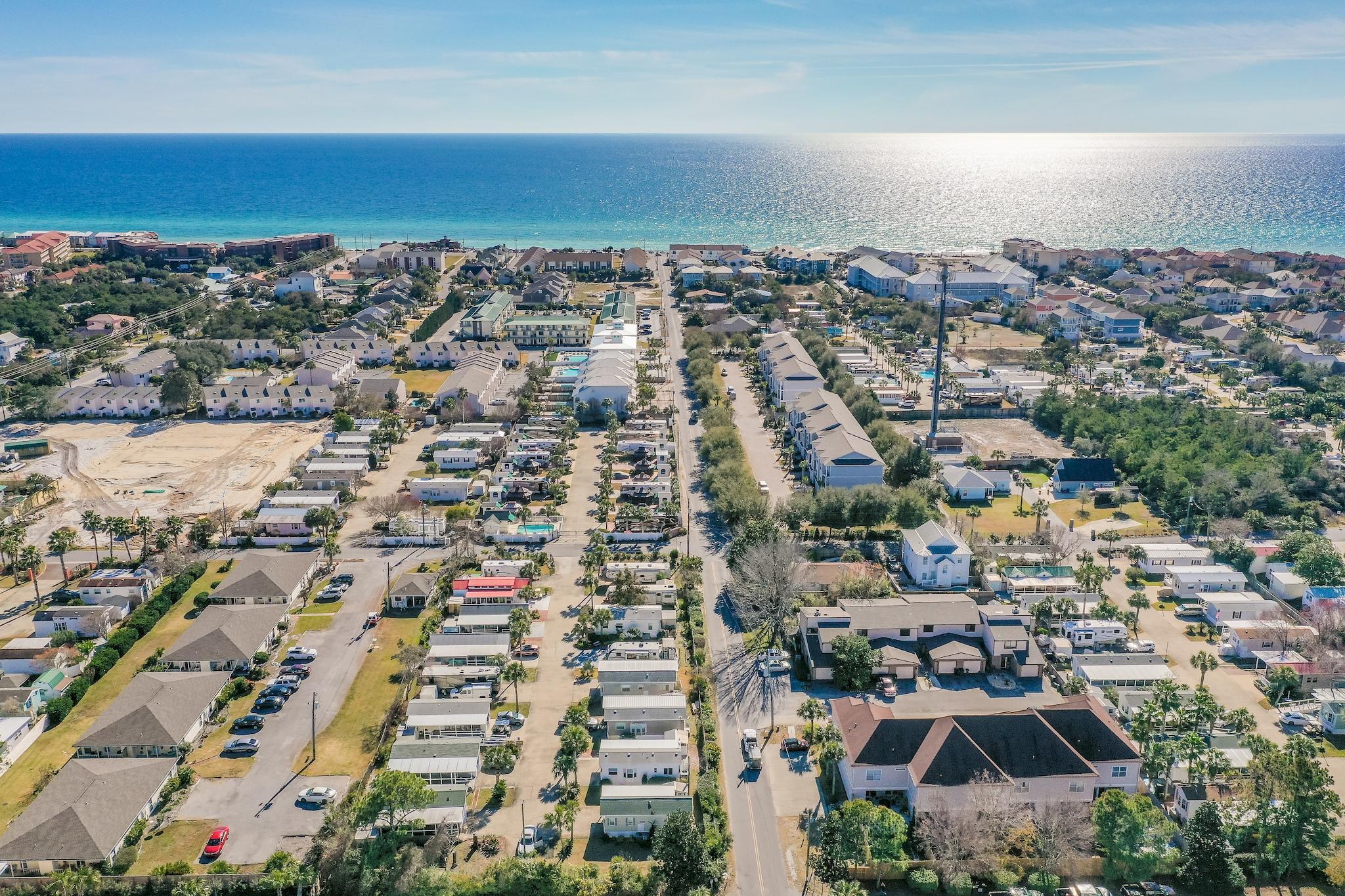 Owner Financing Available! Cozy Tiny home in one of Miramar Beach's most sought after gated communities. This 1BR/1BA home in Fox Run has just been completely remodeled with new floors, appliances, ceiling fans, lights, furniture and more. The open floor plan features dining room, living room and kitchen with breakfast bar. The bath has new vanity with full size tub/shower. Laundry room features plenty of storage with full size washer and dryer. The screened-in covered porch has Trex decking for longevity as you relax and enjoy the sunsets. A convenient out door shower for rinsing off the sand from a fun day at the beach. Located just two short blocks away from the beach. Close to shopping, dining, golf and more. This home would be excellent as a primary home, investment property or second home. (Buyer to verify square footage.)