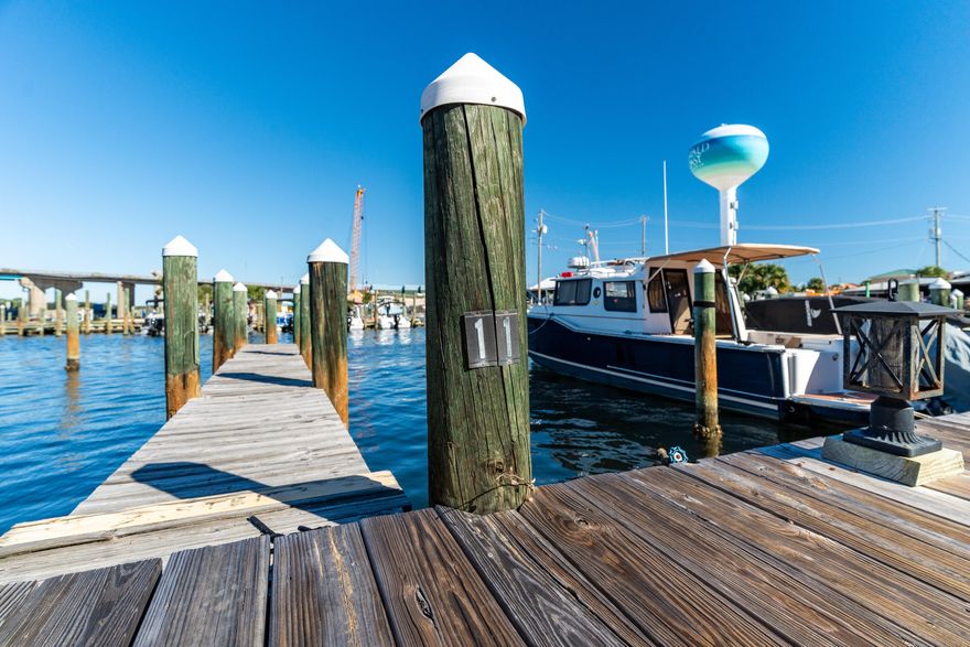 YOUR BOAT SLIP AWAITS! #11 (12x30) INCLUDED! STOP RENTING. START LIVING THE WATERFRONT DREAM!  Repainted interior walls and downstairs ceiling makes this a SHOWSTOPPER. We're not talking about a 'little renovation.' We're talking a TOTAL TRANSFORMATION. STRUCTURAL FORTITUDE: Reinforced floor joists? We've got them. This place is built to LAST. MODERN POWERHOUSE: Brand-new electricals, PEX plumbing, and climate control that'll make your neighbors jealous. GOURMET GLORY: A kitchen that'll ignite your inner chef with sleek cabinetry, stainless steel, and a farmhouse sink that screams luxury. SMART HOME READY: Pre-wired for a 5.2 surround sound system? Yes, we've got that IMPACT RESISTANCE: High-impact doors and windows + hurricane shutters = ultimate peace of mind. PRIVATE BOAT SLIP #11 (12x30) INCLUDED! Stop paying marina fees! Your boat is steps from your door. But that's just the beginning. This gated waterfront community is a playground for the privileged. Dive into the sparkling community pool. Stroll along the private boardwalk on your way to the beach. Relax in the gazebo overlooking the water. And of course, your included boat slip provides instant access to the open water! Location? Prime. Investment? Lucrative. Monthly rentals are PERMITTED, turning this dream home into a cash-generating machine. STOP SCROLLING. START ACTING. This isn't just a listing; it's a LIFESTYLE UPGRADE. DEMAND a private showing TODAY. This opportunity won't wait. Your boat slip is ready. ARE YOU?
