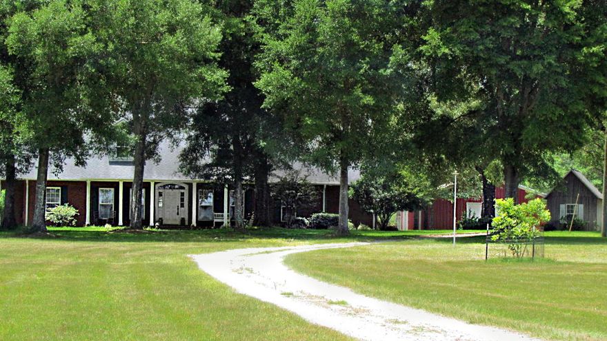 Custom Built spacious Home located on 10 ACRES w/3 car garage just minutes from Whiting Field & Blackwater River State Park. Featuring 10 ft ceilings, crown molding, wood porcelain tile floors throughout, split bedroom plan, & 2 laundry rooms! Kitchen has custom cabinets w/stainless appliances, large walk-in pantry(custom shelving), center Butcher Block Island, breakfast bar, gas stove, & double oven. Master suite w/sitting area. Master bathroom boasts double vanity, Jacuzzi tub, walk-in shower, walk-in closet w/ custom built-ins, plus access to the covered back patio overlooking your 10 acres! Home includes 40 x 40 Shop w/power, two 12 ft. roll up doors w/office, large RV/Boat Carport w/covered boat storage, separate pump house, & playground equipment. Land partially cleared for horses.