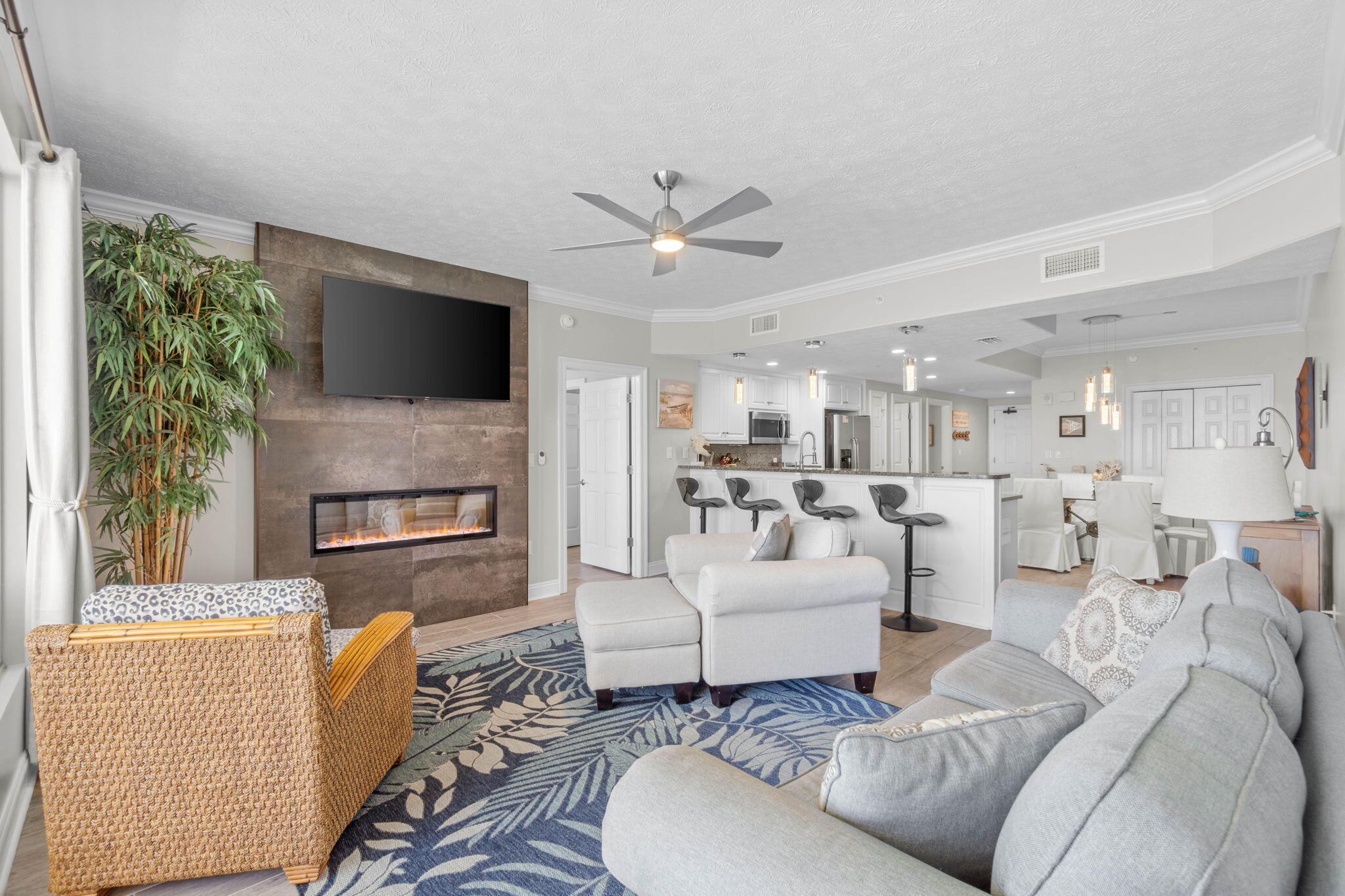 Welcome to Treasure Island Resort, a prominently located gulf-front high-rise condominium in Panama City Beach. This highly desirable, renovated 18th floor unit is comprised of 2 bedrooms plus bunks, 2 bathrooms with 1,370 sq.ft. of an idealistic open floor plan taking full advantage of unobstructed views over the Gulf of Mexico from multiple rooms. A full-blown renovation occurred in 2022 that reflects meticulous attention to detail with notable updates and features throughout in excess of $100,000. This includes updated coastal furniture inside and out, neutral floor-to-ceiling blackout curtains, plantation shutters, neutral paint throughout, wood-look tiles in every room, new light/fan fixtures, new plumbing fixtures, updated kitchen, updated bathrooms, new closet systems  and newer components.

As you walk into the foyer, you are graced with a beautiful custom marble inlay to set the tone for the rest of the unit. The open-concept kitchen boasts contemporary white cabinetry, granite countertops, stainless-steel appliances with a new stove/oven unit and dishwasher, custom pendant light fixtures, recessed lights and pantry. Within the same space is your dining area with ample sitting, custom light fixture and built-in twin-over-twin bunks with a ladder. Adjoining the space is your large living room offering endless gulf views with the ONLY custom built 52-inch fireplace in the entire complex. Open up the glass sliding doors not only in the living room, but also the primary suite to enjoy the beach air on your almost 30 foot long balcony that gives you plenty of space of casual sitting and dining options.

Just off the main living area is the spacious primary king suite. The updated primary bathroom offers a double vanity with a leather granite finish, LED lighted fog free mirrors, private water closet, a glass enclosed chevron marble inlay shower, custom plumbing fixtures and a custom wood shelving system in the closet. The secondary queen suite also offers an updated bathroom with a single vanity with a leather granite finish, LED lighted fog free mirror, a glass enclosed herringbone patterned tiled shower and a custom wood shelving system in the closet.

This fully-furnished condo makes an ideal primary residence, a second home or an investment property with its unique location on the East end of Panama City Beach offering breathtaking sunsets and expansive views down the coastline, providing an unforgettable backdrop. Resort living offers plenty of amenities for everyone to luxuriate in such as a swimming pool, fitness center, on-site restaurant, beach service and a short distance to St. Andrews State Park, favorite local bars, shopping and restaurants. Come see why life is good at Treasure Island Resort today!