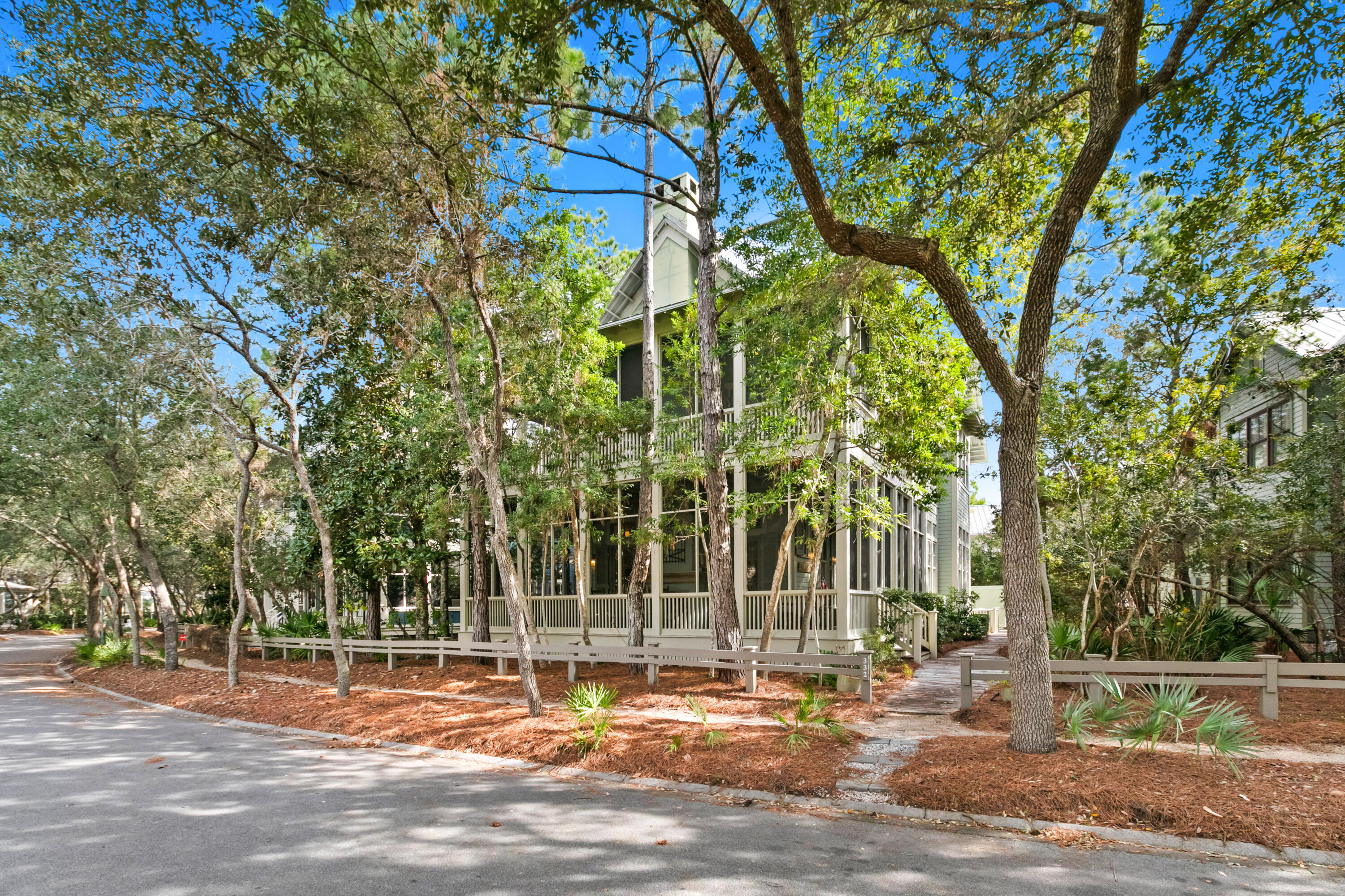 Located on the coveted stretch of Western Lake Drive, this beautiful Watercolor home is perfectly appointed in Old Florida charm. Ideal for a large family or guests up to fourteen people, the homeowners added a carriage house by adjoining it to the original home. Appointed with its own kitchen, it affords family members and guests some privacy during their stays. The primary bedroom is located on the first floor with access to the generous wrap-around porch with wood burning fireplace and plenty of room to lounge or dine al fresco.  A large open floor plan with a warm feel is an ideal gathering place for family and friends. There are 4 additional bedrooms on the second floor each with en-suite baths all with double sinks. Each of these bedrooms have access to the second floor wrap-around