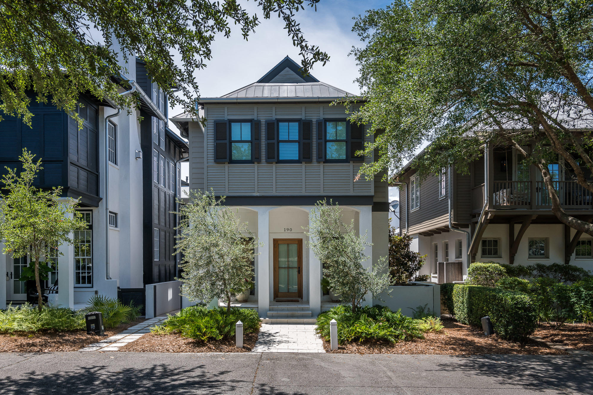 A classic and charming coastal home located in the heart of Rosemary Beach. This exquisite and pristine residence, with garage and carriage house, was completely renovated in 2015 by architect Frank Greene, boasting high-end custom features throughout. As you enter the home from the front porch you are welcomed into an inviting open living, dining and kitchen area, with an abundance of light and exposed beams. A gas fireplace in the dining area creates a warm, cozy feeling. Large kitchen marble island and designer lighting are just some of the amazing elements of this space. Climbing the stairs to the second floor, you will notice the incredible custom washed pecky cypress wood wall, and the beautiful red stained glass windows that were rescued from an old home in Louisiana