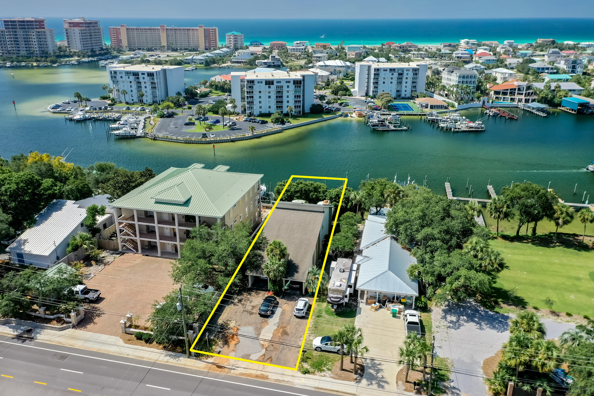 PRICE DRASTICALLY REDUCED BY $100,000! Duplex perched upon one of the highest elevations along the scenic Harbor of Destin, Florida! Includes two deep-water boat slips! Each unit has 2 bedrooms and 2 bathrooms and a patio/deck facing the harbor with potential view of the Gulf of Mexico. There are two covered carports with an abundance of guest parking along the drive! Both units are currently occupied by tenants, both of which involve leases that expire on March, 2021. This is an increasingly rare opportunity to own on the coveted harbor along the Emerald Coast!