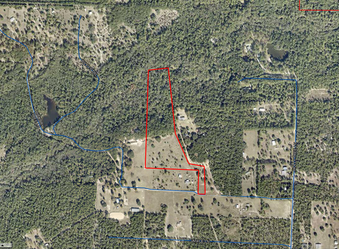Nestled along the scenic Long Creek, this 12+/- acre property offers a perfect balance of open pasture, wooded bluffs, and year-round water access. With 275 feet of frontage on Long Creek, a 30-foot-wide, sandy-bottom creek, and freshwater springs, this land provides a stunning natural setting. The property includes 5.5 acres of pasture and 6.5 acres of wooded bluffs and creek bottom, ideal for those seeking privacy, recreation, or a picturesque homesite. A cypress pond stocked with sunfish and bass adds to the charm. The buildable lot sits approximately 60 feet above the flood zone, ensuring peace of mind, and electric service is available at the property line. Wildlife is abundant, with frequent visits from deer, turkey, and even a resident peacock. The property has deeded access via Hickory Tree Lane and is currently being subdivided from a larger parcel, with boundaries to be finalized upon survey completion. Whether you're looking for a homestead, a weekend retreat, or a nature lover's paradise, this unique property has plenty to offer.