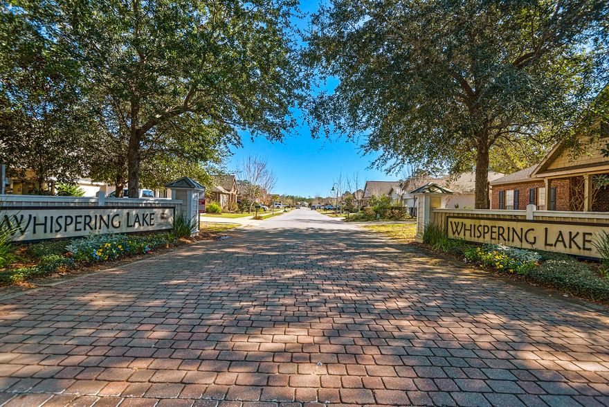 MOVE IN READY and MOTIVATED. Interior has just been freshly painted in a neutral Alabaster color.  Brick ranch featuring three bedrooms, two baths along with an additional bonus room perfect for working from home.  Large master is split from other bedrooms and has a separate walk in shower, soaking tub and walk in closet. Tile and engineered wood floors are throughout the home, privacy fence in the rear and professional landscape lighting front and rear.  Whispering Lake is centrally located close to Publix, Grand Blvd and minutes from several public beach access points along 30A. HOA fees are  $257.66 per quarter for street lights, and dock/lake maintenance.