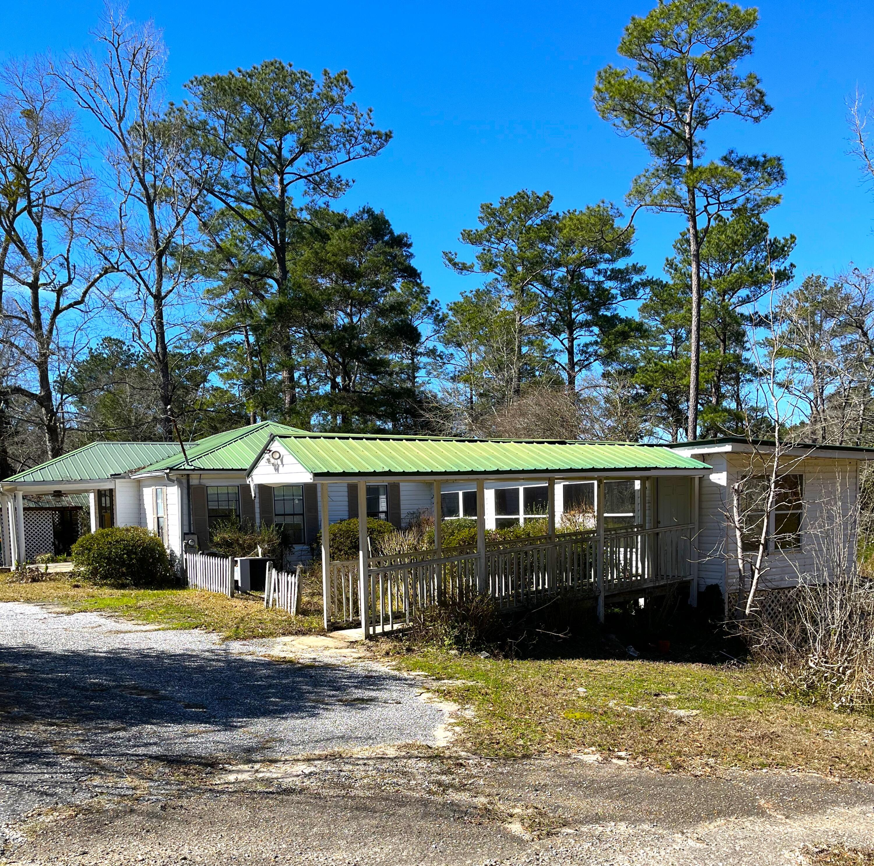Wow! Flippers and builders come take a look at this property. Located on almost a full acre, this home has tons of potential. It was built in 1942 but has been updated and enlarged through the years. The home has 4 bedrooms, 2 baths, an oversized living/dining room and a large addition in the rear with a separate entrance. There is a metal roof as well. This home has the potential to be divided into several living areas.The large lot offers a lot of privacy and is located up a quiet road with only one neighbor visible on the corner lot. The home has not been lived in for awhile and there are no utilities on. Buyer will be responsible to activating any utilities for inspections.