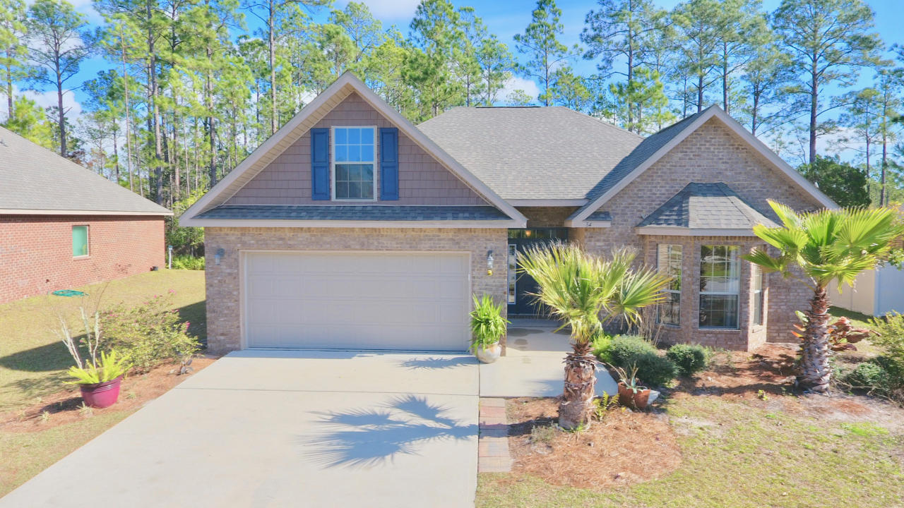 Don't miss this beautiful brick 4/2 boasting a preferred floor plan in a great neighborhood! Fresh paint throughout the open and spacious home provides a fresh canvas to make your own. A private master bath and walk-in closet compliment the oversized master bedroom. The kitchen features beautiful dark cabinets, granite countertops, and a pantry, it opens into the large dining area while looking over the living room. The newly enclosed florida room offers plenty of light with a sliding glass door that opens to the a deck backing up to forest and lake views. The two car garage has a side entry along with a utility sink. Peach Creek is only 10 minutes from popular Rosemary Beach and Seaside, while conveniently located between Panama City beach and Destin.