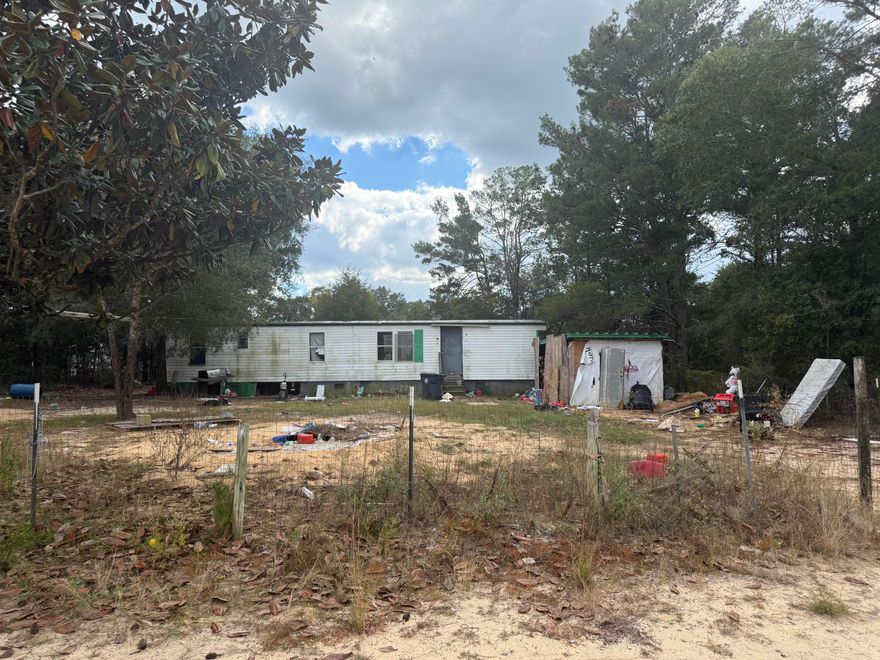 A rare opportunity to secure land with previous utilities.The land parcel at 61 W Juniper Ave in DeFuniak Springs is a residential property located within established neighborhood, Oakwood Hills, and offers a private setting for future home construction or investment. The current home has little to no value.The seller will not remove the current home, trash or furnishings. This sale is AS-IS.Listing agent has resourced lot information from the County Property Appraiser's website.**All information provided via this listing deemed to be reliable but is not guaranteed**. While the listing agent believes that the acquired information is accurate and true, the buyer and/or buyer's agent should verify all details related to this property prior to purchase.