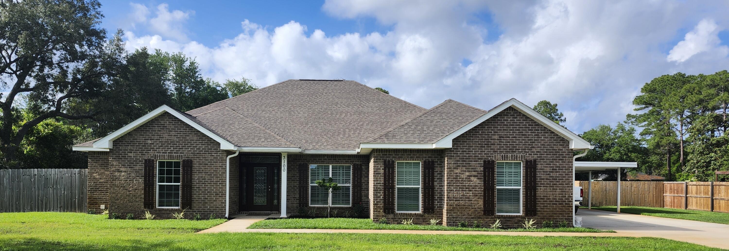 This 4/2.5, 2500 SF all-brick home built in 2019 offers energy efficient 2 x 6 exterior walls, 9-foot Spanish lace ceilings, tray ceilings, crown molding, solid wood doors. It has custom cabinets, granite countertops and plantation shutters throughout.Open-concept design, large main living area, full dining room, spacious kitchen with custom cabinets and beautiful granite countertops, breakfast nook, large bar overlooking the family room, and stainless-steel appliances (which may convey). The cabinets include a Butler's Pantry with smoked-glass doors.The master suite located opposite the additional bedrooms offers a private retreat with a large en-suite bath. The large master bathroom offers a double granite vanity, walk-in shower, six-foot whirlpool tub, and walk-in closet. Three additional bedrooms (single, and Jack & Jill) provide plenty of space for family and guests. Also, with a dedicated home office, you'll have the perfect space for remote work or study.
The large two-car garage enters into the pantry/kitchen area. Offers a carport a large storage building for lawn equipment and other items.
The second driveway takes you to the 1500 square foot insulated shop with a separate heated and cooled one bedroom apartment/office inside. It has three 10 x 10 roll-up doors, and is built to Miami Dade Hurricane specifications. There is also a privacy fence around the entire property.
This home is zoned for Gulf Breeze's top A-rated schools, and nearby shopping and restaurants. NO HOA. Home Warranty.
This property can be subdivided into 3 lots.