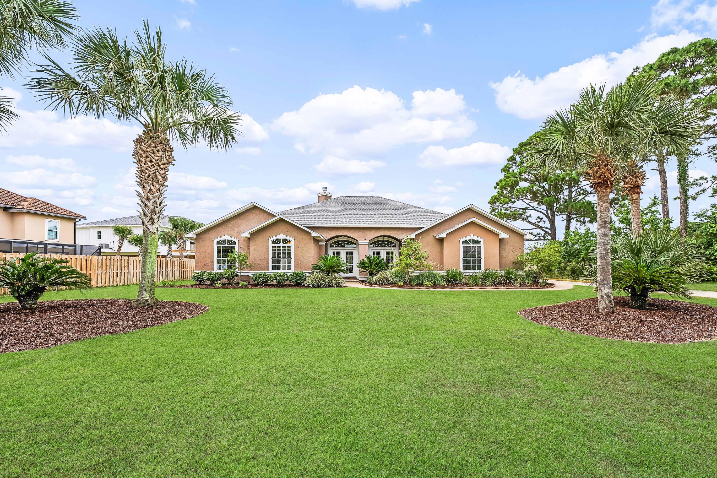Nestled in the sought after golf course community of Tiger Point on the 6th hole, this 2800 square foot home offers a screen enclosed swimming pool with a new pool liner, NEW ROOF, New exterior HVAC unit, soaring 12 foot ceilings and abundant natural light. This home is ideal for entertaining with 5 access points to the gorgeous pool area, a wet bar and 2 separate living spaces. There are a plethora of custom features and upgrades in this home, such as lighted art niches, mosaic marble flooring details, under cabinet bathroom lighting, and custom built-in cabinets. The kitchen comes equipped with abundant cabinet storage, beautiful wood cabinetry, granite countertops, an island with breakfast bar, wall oven, bread warmer, electric downdraft range cooktop, a desk, and a walk-in pantry. The