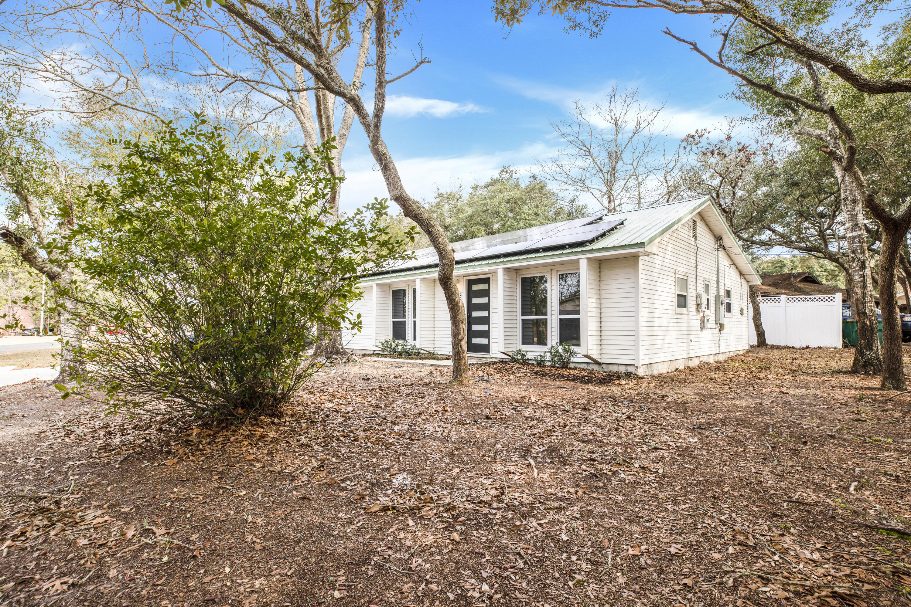 Seller is offering $5,000 in buyer CLOSING COST assistance making it even easier for you to own this eco-friendly home! It comes with new laminate flooring throughout, new HVAC, fresh paint throughout, and all the appliances convey. (Including the washer & dryer) Did I mention the solar panels are paid for? The electric bill savings can be used to enjoy some of the many attractions the Emerald Coast has to offer or to take advantage of the spacious lot and design the outdoor space of your dreams. Whatever your preference, this beautifully renovated home is a must see! Buyer to verify all information deemed important. Call to set up your showing today!