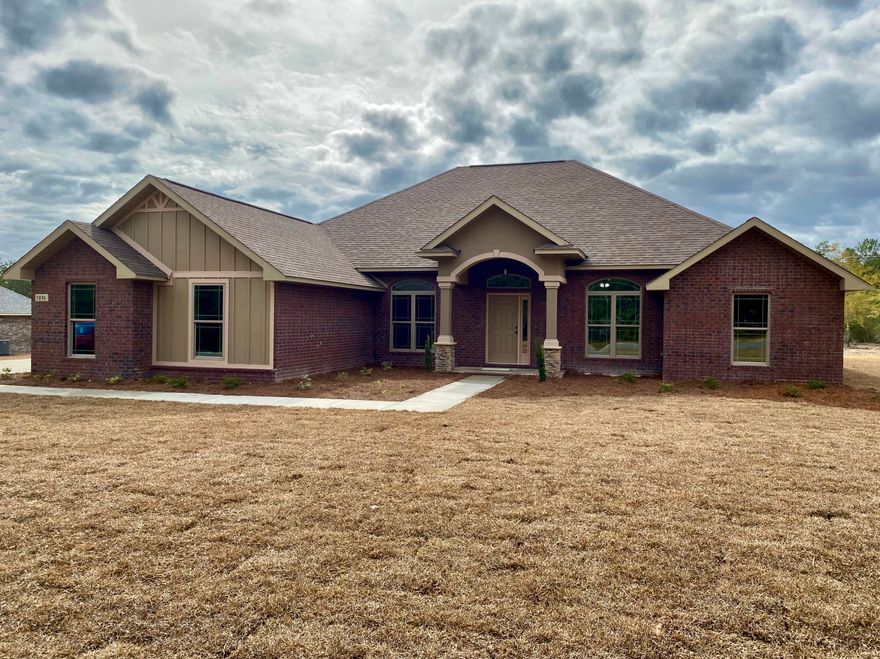 Our popular 2929sqft floor plan has a 3-car Garage and 1 Acre of land, conveniently located with easy access to I-10 and less than 30 minutes from the sugar-sand beaches of Navarre. This 4 bedroom/ 3 bathroom plan features a grand 20'x20' Florida Room that looks out on a backyard with excellent depth. Quality handmade maple cabinets adorn the kitchen, complimented with recessed lighting overhead and under-mount lighting over the granite countertops. The front porch features double columns with stacked-stone bases, giving this beautiful home a kingly look and excellent curb appeal!This home is energy efficient with a 14 seer HVAC and low-E vinyl windows. Thomas Homes was the winner of multiple Parade of Homes awards in 2017, and has been claim-free since 1993!