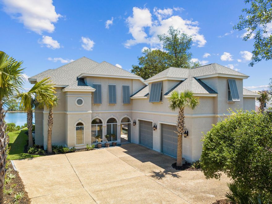 UNDER CONTRACT with KICK-OUT CLAUSE. This elegant waterfront home in The Preserve on the Bay is all about the views. The elevated position means that even the first floor has interrupted views across the serene bay and bayou from almost every room. The living room delivers some of the best vistas through double French doors and a curving wall of glass. Gleaming wood flooring and a feature fireplace add to the comfortable ambiance. More stunning views will wow guests from the dining room and gourmet kitchen with island and breakfast bar. There's a walk-in pantry, laundry room and guest bath on this main floor along with a versatile bonus area. Use it as a den, craft room, library, media space or home gym, or furnish it as an additional guest space.