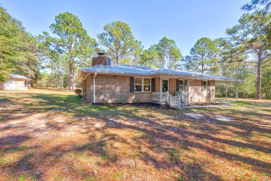 This quaint 3BD/2BA home is nestled amongst mature Pine Trees on 3.89 acres and is a nature lovers Paradise! As you drive up to the home through your private gated entrance you're welcomed by the serenity of nature and a open 2 space Carport. From the covered front porch you step into the spacious open floor plan of the living, kitchen and dining area. Off the dining area is a spacious enclosed patio, which is perfect to enjoy that morning cup of coffee! Down the hallway features the Master Bedroom with en-suite bath and 2 spacious Guest Bedrooms with shared bath. The kitchen features tons of storage along with counter space making meal prep easy. The open floor plan of the living, kitchen, dining along with patio are perfect for entertaining both indoors and out. Nature's Paradise Awaits!