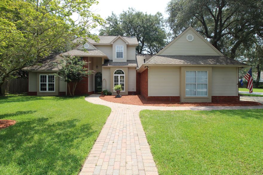 A beautiful corner lot setting for a beautiful home! Nestled in the gated community of Southwind, you will enjoy the beauty of the large, manicured lawn with paver sidewalk leading up to the front door and to the side entry of the two-and-a-half car garage.  This home has all the features you would expect of a custom home and more.  As you enter the house, you will admire the cathedral ceiling and openness of the first story, plenty of sunlight gleaming across the travertine floors.  Straight ahead is a spacious living room featuring 10' ceilings with crown molding, stately gas fireplace and graceful column with the formal dining area just off to your right.  Stepping thru an archway leads you to the open concept kitchen, family room, breakfast nook; a fantastic space for entertaining and