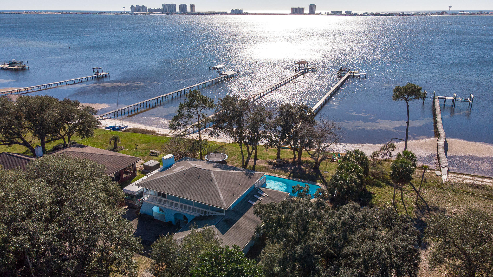 BACK ON MARKET! Waterfront and Pool! Listed under recent appraisal value! Don't miss this opportunity! 100' on Santa Rosa Sound with sunset AND sunrise views. Boat dock includes new 8000 lb boat lift, multiple swim platforms, running water, and electricity. Large lot is almost half and acre with mature trees. Plenty of parking for RV, boat, extra cars.This 4 bedroom, 2.5 bath home was completely repainted and new flooring installed in 2016. New AC unit upstairs and new water heater. The spacious eat in kitchen has a breakfast bar, double ovens, new dishwasher, new stove and walks out to large 40'enclosed patio. Upstairs has a large deck overlooking the pool and the sound. Patio by pool extended, new pool pump motor, new gutters and a french drain installed.