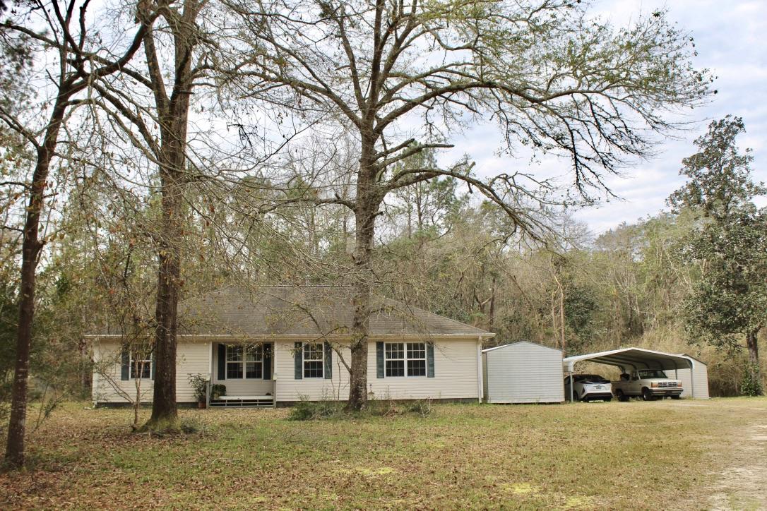Beautiful Country Home & 13 acres. This Ronnie Jones built 3 bed, 2 bath custom built home has a split floor plan with open living dining room and cathedral ceilings. the house is very open, airy and full of light. large master bedroom with walk in closet and an attached master bath that includes garden style tub and detached shower. Custom kitchen. New 2019 Whirlpool four door refrigerator. 2018 Bosch dishwasher. Over sized pantry and utility room. New A/C 2017. Home is in ''like new'' condition. Wall to wall carpet except in kitchen, utility room & bath rooms. No value given to the old house that functions as a workshop . Cash or conventional loans only. Seller will need at least 7 days after closing to vacate. Seller firm on list price