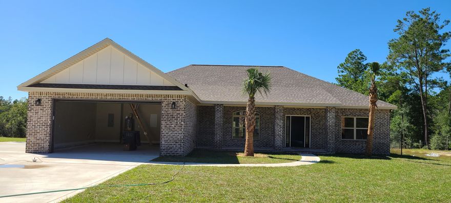 Beautiful large 2565 sq ft All brick home to be built sitting on a 5.42 AC lot. with natural spring fed creek that flows through it. Inside you will find an open concept with a huge family and dining rooms with ten ft ceilings and crown molding. Beautiful kitchen with granite counter tops and stainless appliances including the refrigerator. Cabinets with soft close doors and drawers. Master bedroom is huge and has his and hers walk in closets in the master bath. Master bedroom features a trayed ceiling with crown molding. Additional bedrooms are very large as well. The home has an enormous 27 ft cover front porch and an even larger 33x7 cover back porch for enjoying evening for morning coffee! Still time to choose flooring and colors! Make this your custom dream home!