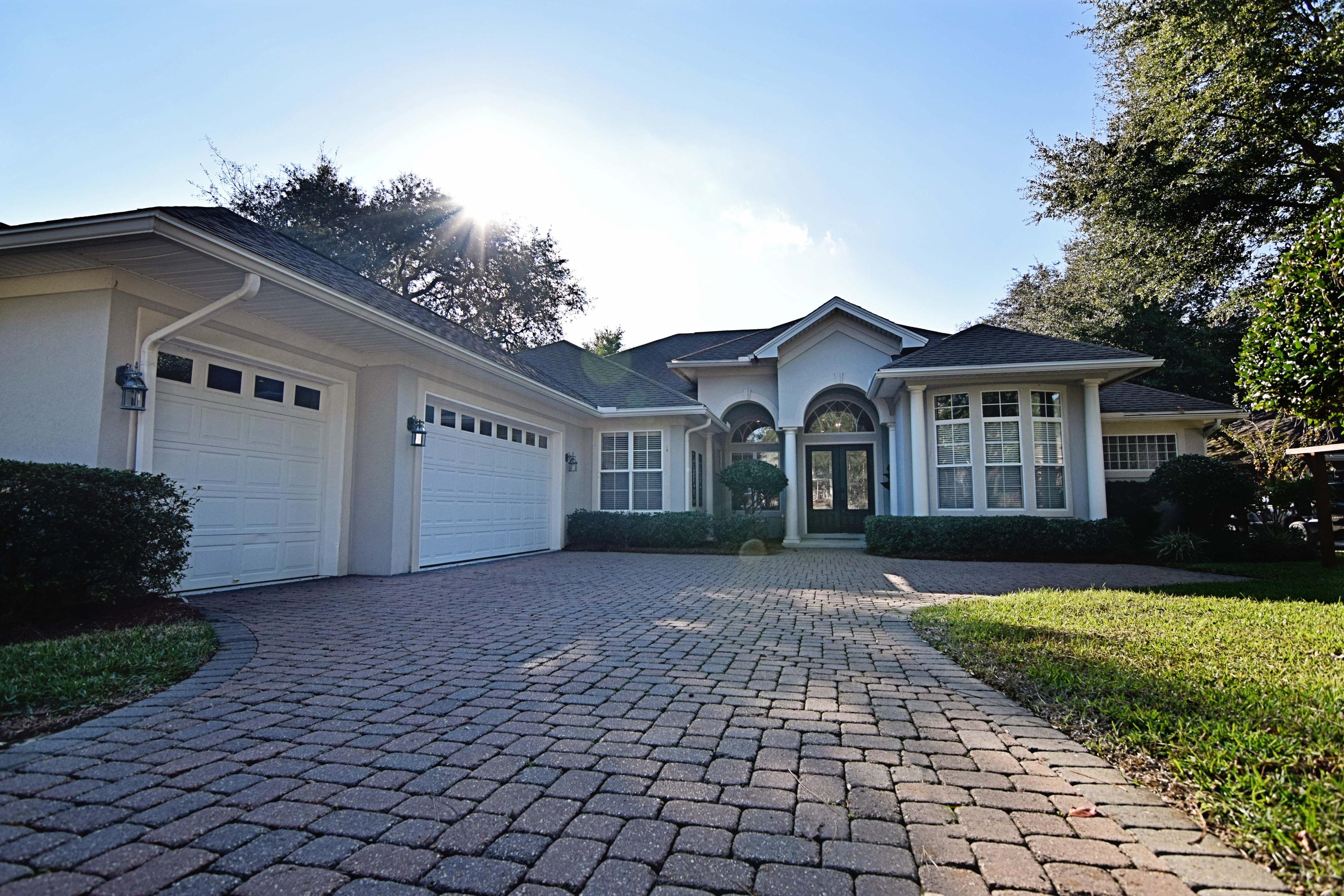 Experience comfortable Florida-living in this open and spacious executive-style home in Niceville's beautiful, family-friendly neighborhood, Swift Creek . This 3bed/3bath/3car-garage gem of a home can be found at the beginning of a quiet cul-de-sac with beautiful landscaping and cobblestone drive. Even before entering the home, you can't miss all the special details; birdbath, decorative metal work, and stand for porch swing. From the street, its large front door and windows certainly make a statement. Upon entering, you'll notice a large open living space with room for formal dining area and living room with decorative inlaid tile flooring and custom light fixtures throughout. Most noticeable are the windows and doors that frame a view of the beautiful