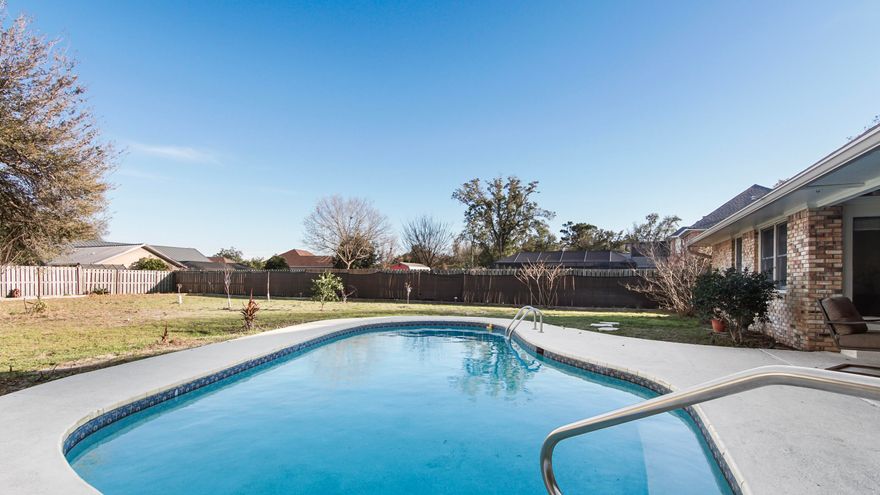 Move-In Ready Pool Home, Half Acre Lot, No HOA, Flood Zone X, Minutes to the Boat Ramp! Discover your private oasis in the highly sought-after Kings Point community! Sitting on a serene, fully fenced half-acre lot, this beautifully maintained 4-bedroom, 2-bathroom all-brick home offers 2,686 sq. ft. of thoughtfully designed living space. Best of all, it is located in Flood Zone X. Step inside to sun-filled living areas highlighted by beautiful hardwood flooring, soaring vaulted ceilings, and a cozy wood-burning fireplace. The chef-ready kitchen is a showstopper, featuring gleaming granite countertops, a spacious walk-in pantry, abundant cabinetry, and an upgraded suite of high-end, WiFi-enabled Samsung smart appliances. All four bedrooms are generously sized and feature comfortable carpeting, providing ultimate flexibility for hosting guests or setting up a dedicated home office. The expansive primary suite serves as a true retreat, boasting direct pool access and a spa-inspired en-suite bath for a seamless indoor-outdoor lifestyle. Your backyard is an entertainer's dream. Step out onto the covered back deck and overlook your sparkling, private in-ground pool, within the fully fenced backyard the perfect setting for summer barbecues, pets, or quiet evenings under the stars. Unmatched Exterior Features & Boating Lifestyle: With absolutely NO HOA, you have the ultimate freedom. The oversized driveway and two-car garage provide abundant room to park your RV, and with the nearest boat ramp just 3 miles away, storing your boat on-site is a breeze. Green thumbs will love the dedicated greenhouse, while the detached storage building offers endless organizational possibilities. Major Updates for Ultimate Peace of Mind: This home is completely move-in ready with high-ticket updates already completed for you: New Water Heater (2026) New Septic Tank & Drain Field (2025) New Pool Pump (2025) HVAC Recently Serviced (2025) Roof Replaced (2019) Conveniently located near top-rated schools including Mosley High School and University Academy, great shopping, and dining, plus a short commute to Tyndall AFB or the Navy Base. This Kings Point gem blends comfort, luxury, and an unbeatable Florida lifestyle into one exceptional property. Schedule your showing today!