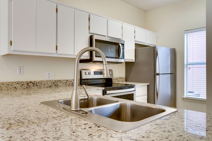 Move-in ready, this beautifully updated end unit town home is just over one block from a nice boardwalk entrance to the beach. All tile 1st level, new S/S appliances, new carpet on the 2nd level, fresh paint, new fixtures along with granite counter tops in the kitchen and baths. Plus a one car garage for your beach toys! 9 ft. ceilings downstairs, charming kitchen open to the great room and vaulted ceiling in upstairs master make for a roomy feeling. Gulf Walk boasts a large community pool with gazebo which is right out your back door. The great room sliders open to a covered porch that is steps away from the pool entrance. Upstairs offers a master bedroom & bath w/ a balcony over looking the pool plus a 2nd bedroom with private bath. Low, low HOA fees & short term rentals allowed.