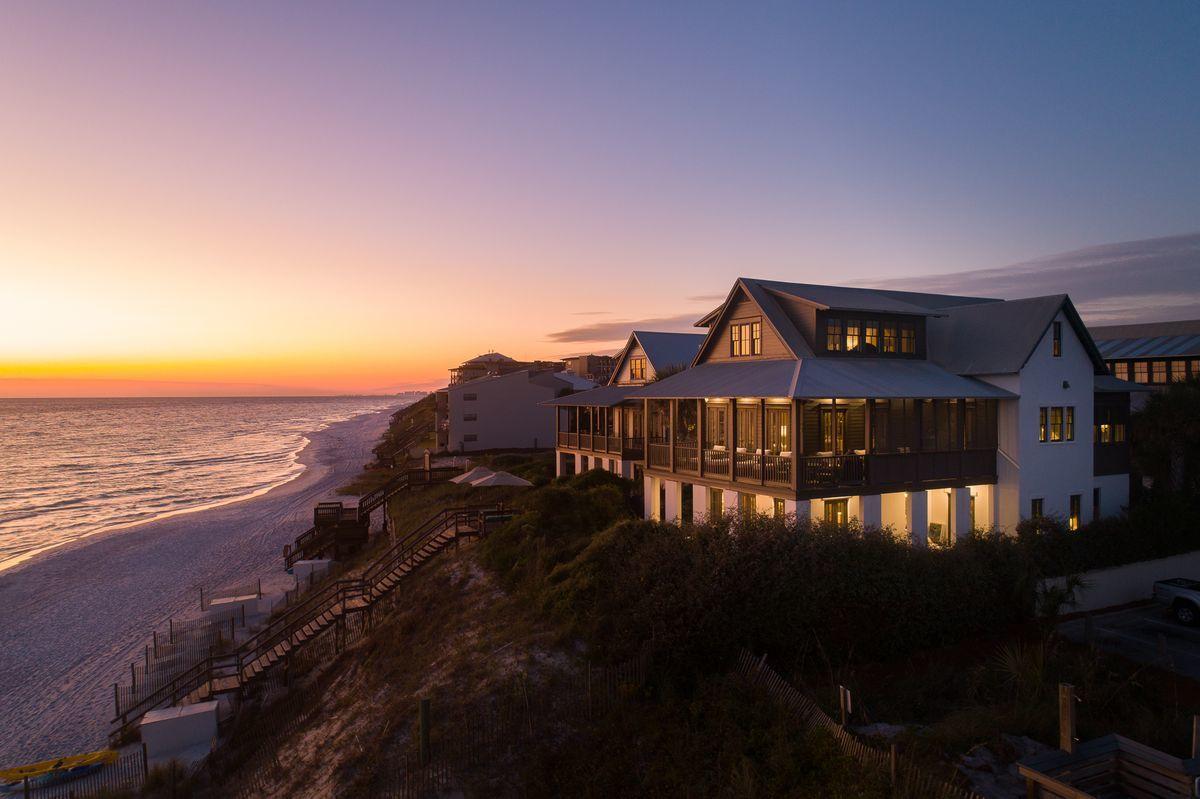 This luxurious Gulf-front retreat resides on the high bluffs of Blue Mountain Beach. The design and construction bear the distinctive quality of builder Davis Dunn with interior design by Urban Grace Interiors. A private boardwalk with seating serves as access to the beach for this small gated enclave of four rental restricted homes. Each of the spacious five bedrooms of this home offers en suite baths and views of the Gulf of Mexico. One primary suite is conveniently located on the first floor, while the second primary suite encompasses the entire third floor. The kitchen, media den, dining and living room, guest suite and powder bath comprise the second floor. A louvered screen offers privacy to the covered deck with outdoor grilling just outside of the kitchen. A dream bunk room