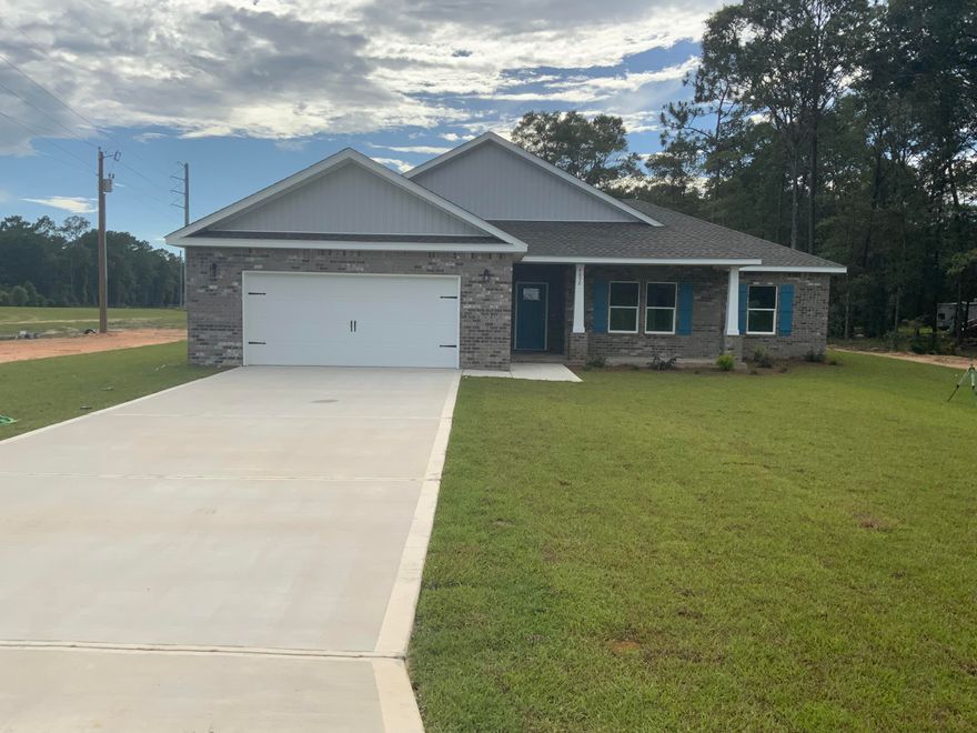 CRAFTSMAN STYLE HOME ON BEAUTIFUL ACRE LOT (No HOA), peace and quiet in the country paved road with easy access to Highway 90 for commute East/West. 9' Ceilings thru-out, LVP in common areas, carpet in bedrooms, work island with bar seating in kitchen, shaker style cabinets, dining area, pantry, stainless steel appliances, mudroom plus large laundry room off kitchen, owners bathroom features double vanities, oversized tiled shower plus garden soaking tub and walk-in closet, open floor plan with 3 other good size bedrooms off great room, additional bath also has double vanities.  Large covered rear porch for relaxing and entertaining, 2-car garage and covered front porch, all brick construction.