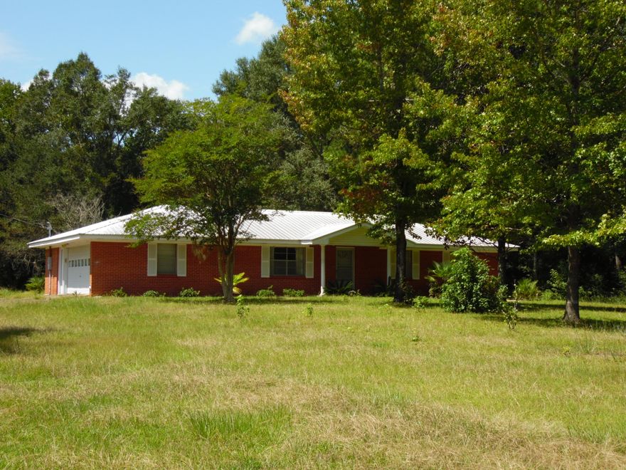 Just over the Walton County line is this fabulous all Brick home 3 bedrooms, 2 1/2 baths, metal roof, AND a separate brick garage/workshop on .68 acres. Living area is 1363 sq. feet heated and cooled with a large 2 car garage and large utility room with a 1/2 bath,(could be converted to an extra bedroom and bath, since there is a detached garage also) bringing the total sq. footage to 2000+. Each bedroom is large and spacious. There are some handicap features.  Kitchen is large with enormous amount of cabinets. Home was originally built by Earl Alford Construction Company, a premiere builder for the area.  It is near Morrison Springs and the Ponce de Leon State Park for swimming.Near to Panama City and  South Walton/Freeport areas.  Easy to show, call today.