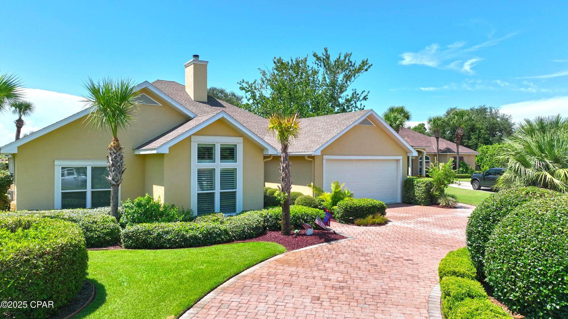 Welcome to Legend Hills in Bay Point! A private gated golf course community. The home is located between the 9th green and the tee box of the 10th hole par 3 over the water, and on the cul de sac of Dragons Ridge Road. This 4 bedroom, 3 bath home includes a beautiful open floor plan with incredible sunset views over the screened pool patio and the golf course. Soaring 12' ceilings with crown moldings, built-in cabinets, and the gas fireplace create an open welcoming home. The oversized 2-car garage includes a separate garage door for your golf cart, two large closets, built-in storage cabinets, and polyurea floor coating with a lifetime warranty. Renovated in 2018 after Hurricane Michael the home features a new 3-dimensional shingle roof, spray-foam insulation, new HVAC systems, all new hurricane-rated windows and doors, engineered acacia hardwood flooring, completely renovated kitchen (new cabinets, quartz countertops, KitchenAid stainless steel appliances, etc.), Waypoint cabinets in the kitchen, great room, and master bathroom, a new pool screen enclosure, refinished gunite pool, new pool pump & filter, and more. The master bathroom includes a huge walk-in closet, and the frameless glass shower includes a steam generator with bluetooth speakers, lighting, and aroma therapy. Bay Point residents have 24-hour security, gated entry, the Nicklaus Golf Course, the Point South Marina that hosts the annual Bay Point Invitational Billfish Tournament, and a golf cart friendly community. Often called the best neighborhood in Bay County. The home is vacant and easy to show. Call today to schedule your private tour and submit your offer.