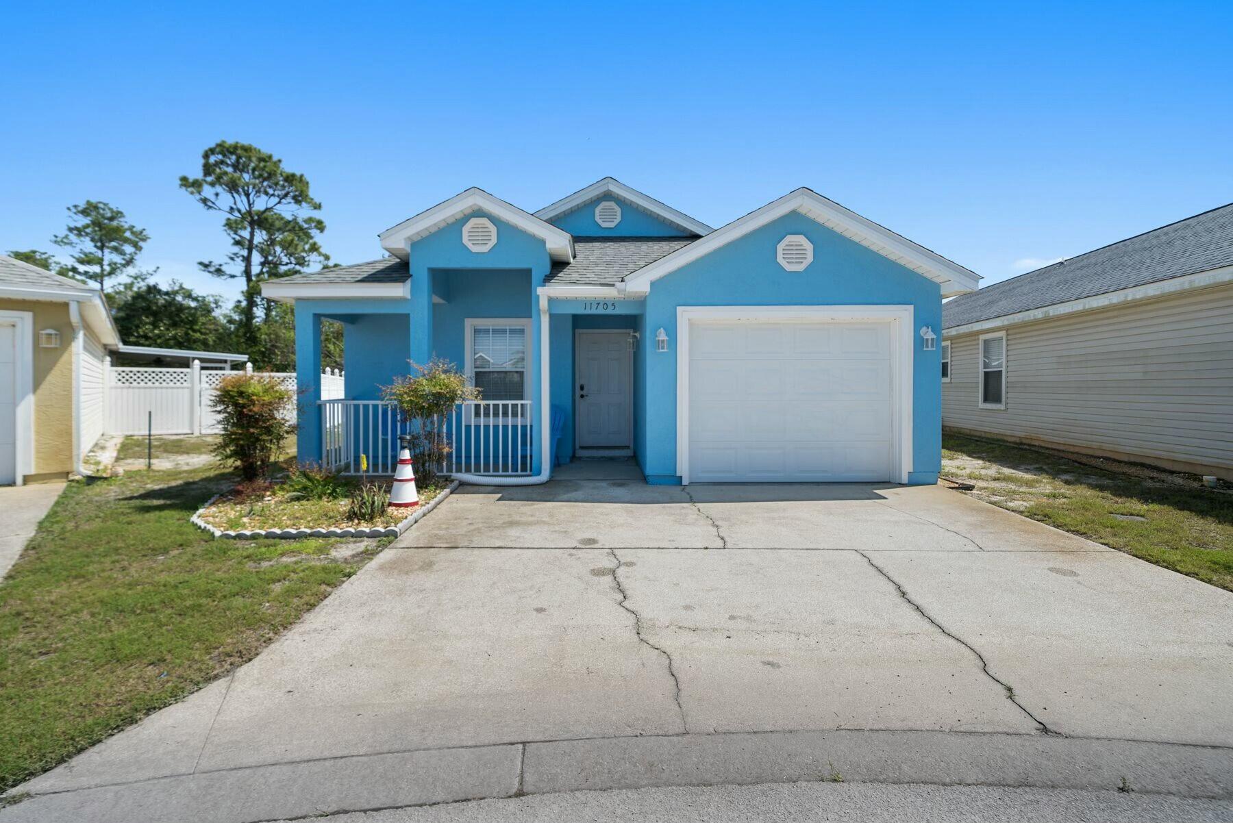 Nestled on a well-maintained lot, this cute beach cottage is surprisingly spacious, with three beds, two baths and a garage. Enviably located, it is close to Shipwreck Island Water Park and just a five-minute drive from the beautiful white sandy beach. It offers laid-back living all on one level with the added advantage of community pools, family-friendly amenities and gated security. A covered porch entrance opens into a tiled hallway with doors leading to two generously sized guest bedrooms. One is currently furnished as a bunk room, and the other has pine furniture, including a queen bed. Both rooms have built-in closet space. Further along the hall, there's a well-appointed family bathroom and a laundry closet. The hall opens into a light-filled living room with an open kitchen. Check out the full range of white cabinets and storage. Stainless steel appliances include a French door refrigerator with an ice maker. The dining area provides a bright space for entertaining, adjoining the well-furnished sitting area. Doors open onto a private outdoor porch, which provides a pleasant sitting area for unwinding at the end of the day. The master bedroom is generously sized and includes an ensuite bathroom with a twin vanity and a tub/shower combo. This charming cottage has the added advantage of a one-car garage with space to store beach chairs, bicycles and a golf cart for getting around the local community. A paved parking area in front of the home provides space for two vehicles. Located in the friendly gated community of Palm Cove Phase II, this single-story home comes with access to two community pools, a playground and common areas. Short-term rentals are permitted, making it suitable as a vacation home or investment property. Annual rental projections are in the region of $26,000 to $35,000. Conveniently close to schools, restaurants, Publix and Highway 98 attractions, this spacious home is just a five-minute drive to public beach access. Offering spacious living at an attractive price point, this turnkey property is ready to welcome you and your guests.

