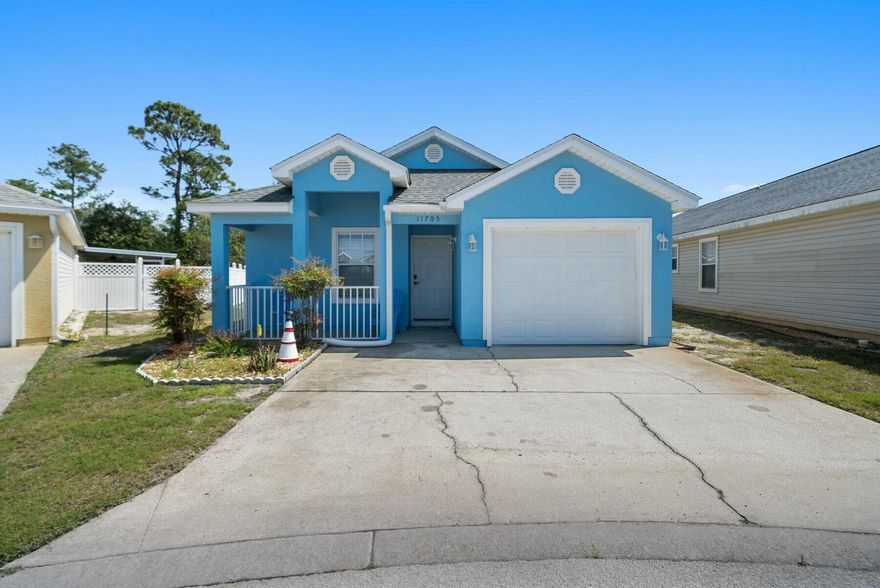 Nestled on a well-maintained lot, this cute beach cottage is surprisingly spacious, with three beds, two baths and a garage. Enviably located, it is close to Shipwreck Island Water Park and just a five-minute drive from the beautiful white sandy beach. It offers laid-back living all on one level with the added advantage of community pools, family-friendly amenities and gated security. A covered porch entrance opens into a tiled hallway with doors leading to two generously sized guest bedrooms. One is currently furnished as a bunk room, and the other has pine furniture, including a queen bed. Both rooms have built-in closet space. Further along the hall, there's a well-appointed family bathroom and a laundry closet. The hall opens into a light-filled living room with an open kitchen. Check out the full range of white cabinets and storage. Stainless steel appliances include a French door refrigerator with an ice maker. The dining area provides a bright space for entertaining, adjoining the well-furnished sitting area. Doors open onto a private outdoor porch, which provides a pleasant sitting area for unwinding at the end of the day. The master bedroom is generously sized and includes an ensuite bathroom with a twin vanity and a tub/shower combo. This charming cottage has the added advantage of a one-car garage with space to store beach chairs, bicycles and a golf cart for getting around the local community. A paved parking area in front of the home provides space for two vehicles. Located in the friendly gated community of Palm Cove Phase II, this single-story home comes with access to two community pools, a playground and common areas. Short-term rentals are permitted, making it suitable as a vacation home or investment property. Annual rental projections are in the region of $26,000 to $35,000. Conveniently close to schools, restaurants, Publix and Highway 98 attractions, this spacious home is just a five-minute drive to public beach access. Offering spacious living at an attractive price point, this turnkey property is ready to welcome you and your guests.

