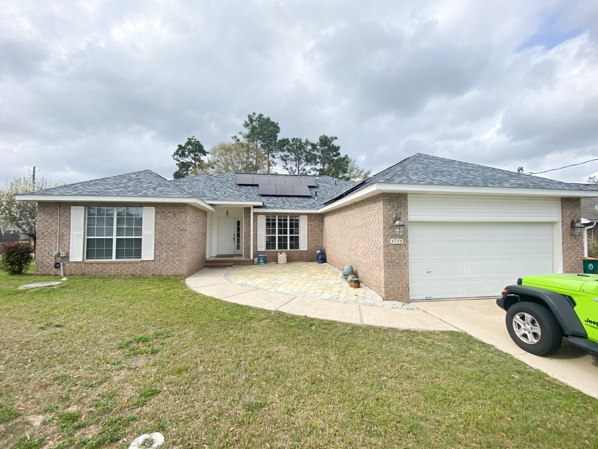 Move in ready! waiting for you and your family. As you step in the front door you will right away notice the beautiful herringbone ''wood'' tile floors throughout the main areas and the vaulted ceiling that will impress. This home features 4 bedrooms and 2 full baths utilizing a split floor plan.  There is a mini split ac installed in the garage making working on cars and hobbies very comfortable during those hot summer months. New roof installed in 2020 and a evirotemp 40 gallon water heater installed December 2021. Solar Panels are completely paid off and are just waiting for you to take advantage of those LOW electric bills. Spend your time having cook outs on your back porch with friends and family. THIS IS THE ONE.
