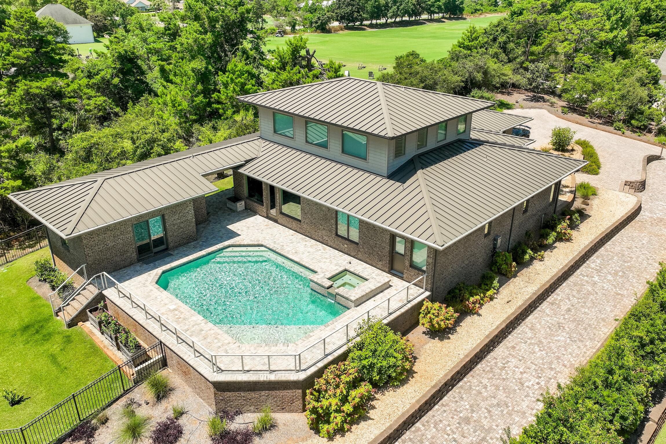 Nestled in the prime west end of 30A, this exceptional custom-built, mid-century modern home offers a rare blend of coastal luxury and serene living. Situated on a spacious 3/4 acre lot boasting one of the highest elevations (50-55 ft) on the coast, this property offers unparalleled privacy. Adjacent to Santa Rosa Beach Golf Course, you can enjoy direct access to the driving range & clubhouse, making it a haven for golf enthusiasts. The elevated position not only offers breathtaking views of the surrounding natural landscape but also ensures a sense of exclusivity and tranquility. Whether enjoying the expansive outdoor spaces or cozy fire pit, relaxing by the heated saltwater pool & spa, or exploring the pristine beaches nearby, this 5 bedroom home epitomizes the allure of coastal living!