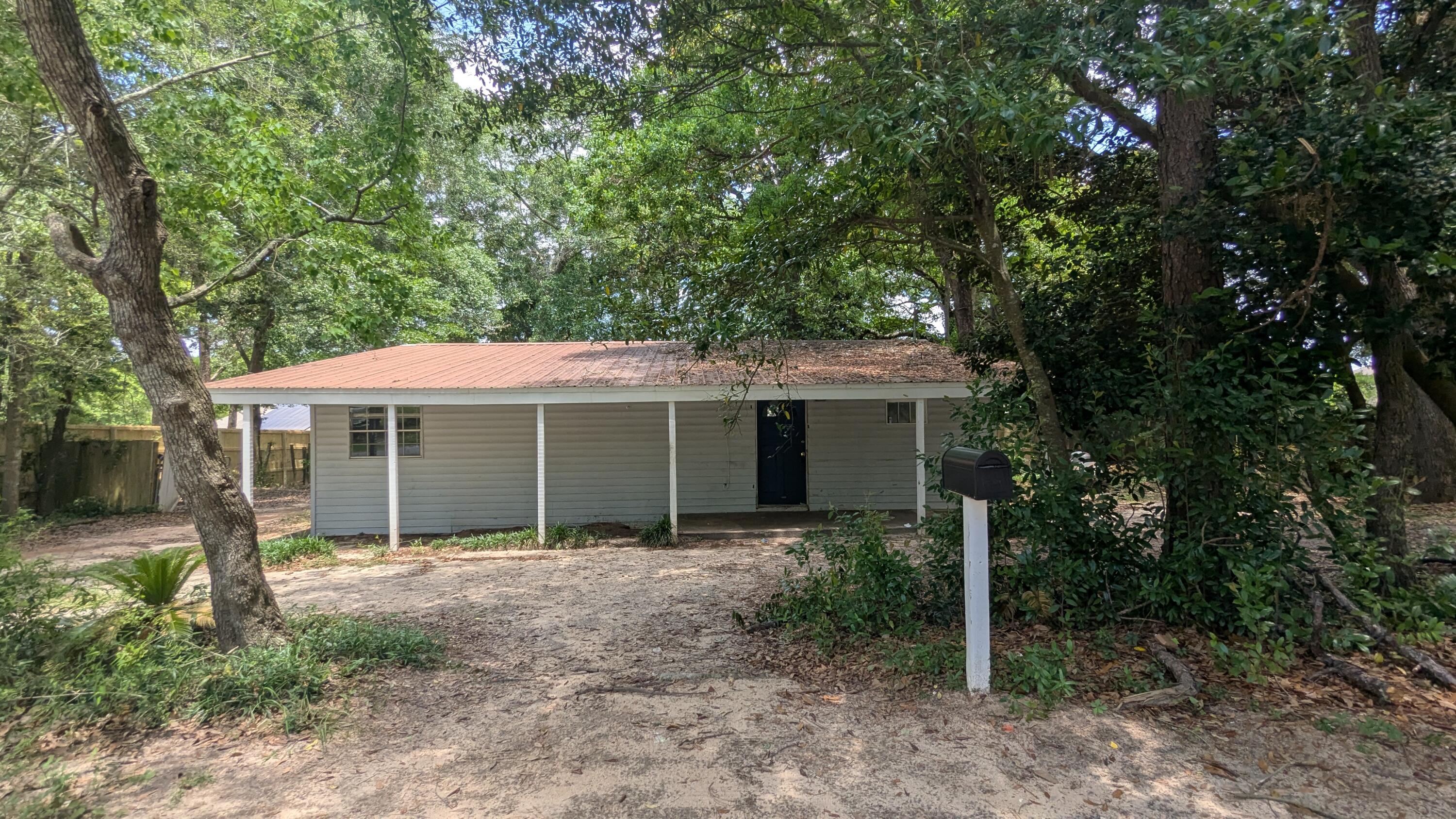 CALLING ALL INVESTORS! Large fixer-upper on huge lot in Crestview. This rustic single family home has been converted to a 4 bedroom 2 bath residence. Spacious living room. Formal dining space. Roomy kitchen. Good sized rooms, some without closets. Garden tub in the master bathroom. Large covered front porch and covered back porch, plus an additional open patio in the back. This property is distressed and in need of updates and TLC, but it would make the perfect family home or income property for the handy homeowner. Vacant and easy to show.