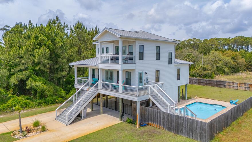 This 4/3 2018 Build has it all ...  The top-floor primary suite features a private balcony with unobstructed views of the Santa Rosa Sound. Designed for relaxed coastal living, the open floor plan includes upscale finishes and spacious indoor-outdoor flow. Outside, enjoy a private gunite pool with waterfalls, a sun deck, paver patio, and 380+ sq ft of covered porch space--plus room below for boat parking or entertaining. A-rated schools, shopping, and just minutes from Pensacola Beach and the Oriole Beach Boat Ramp