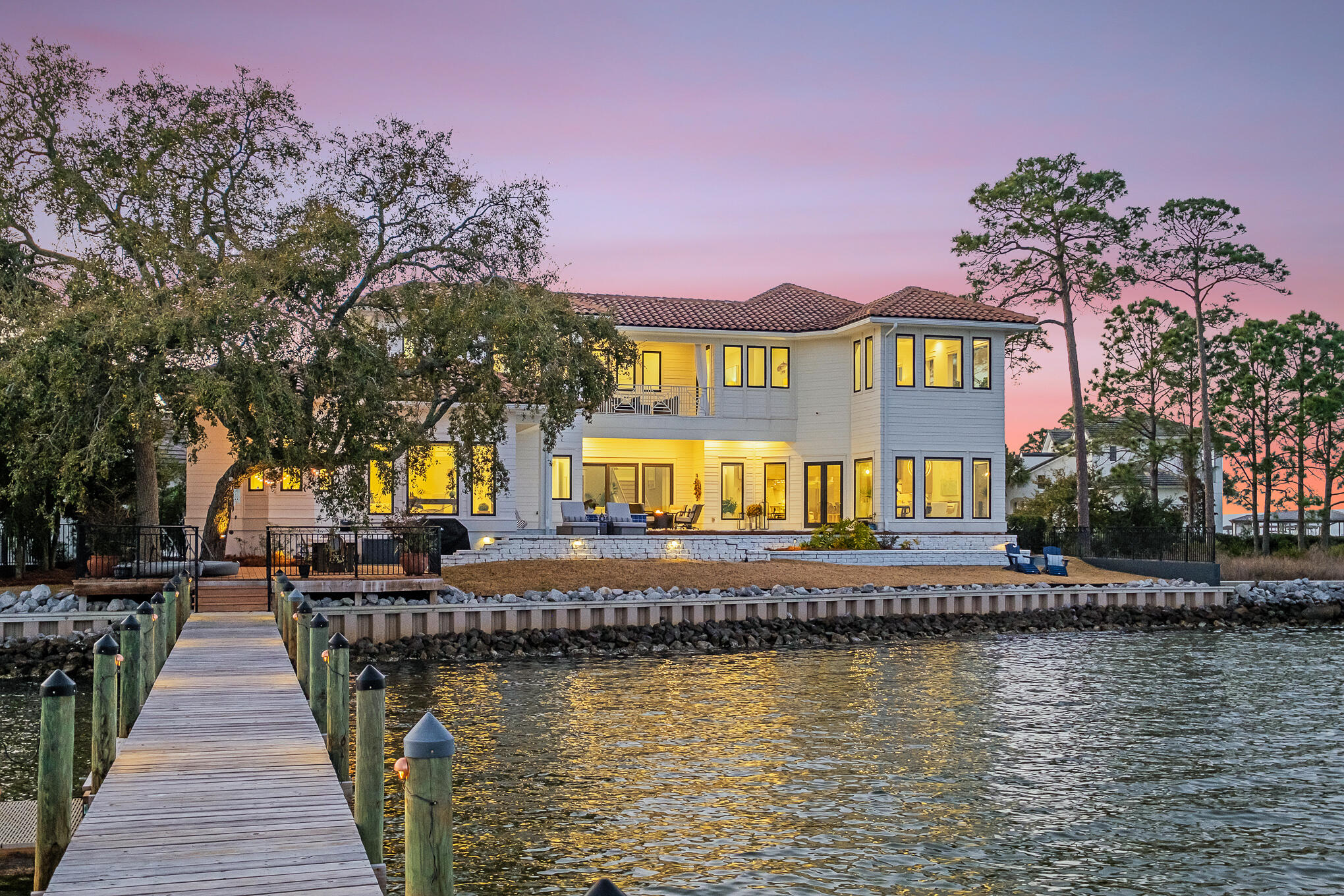 Behind the gates of  Grand Cove sits this beautiful estate, with some of the most amazing bay views we have seen. Architect Geoff Chick masterfully updated the home in 2018, taking full advantage of the prominent site and selecting timeless and exquisite finishes. With 135 feet fronting the Choctawhatchee Bay, this 4,217 sq ft home offers a lifestyle filled with beautiful sunrises, watching dolphins play and enjoying all the bay has to offer.  The pool court bathed in custom tumbled marble, serves as the backdrop for lazy days by the heated, salt-water pool or cool nights in the spa stargazing over the Bay. Your family and friends will make forever memories from this stunning home.