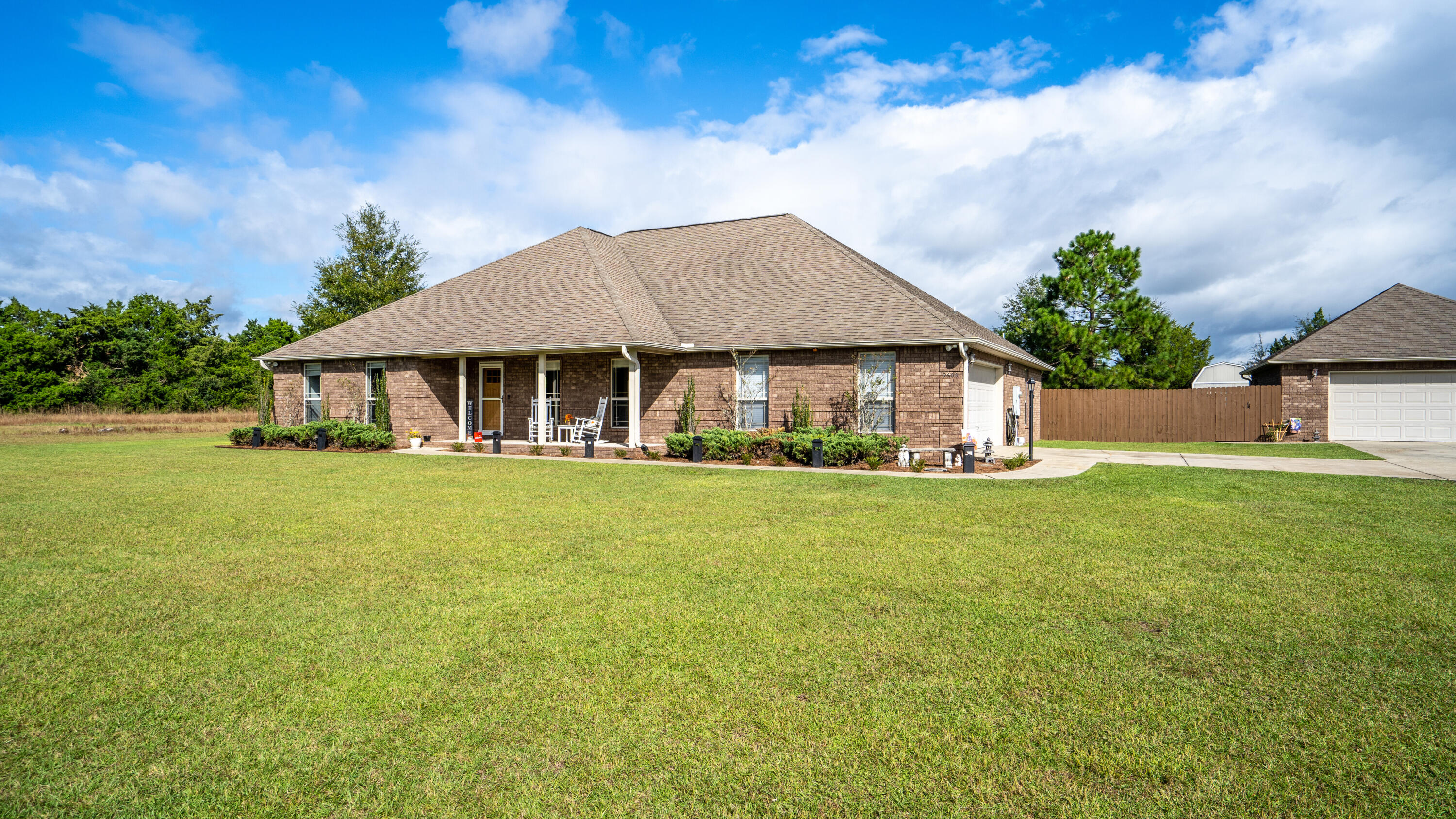 SPECTACULAR BRICK HOME ON WELL MAINTAINED 2.46 ACRES SOUTH OF I-10! THIS PROPERTY BOASTS A 720 SF DETACHED BRICK WORKSHOP/2ND GARAGE COMPLETE W/ ITS OWN SEPTIC SYSTEM, W/FULLY PLUMBED, FRAMED BATHROOM READY FOR FINISHING FOR PERFECT MAN CAVE, GUEST HOUSE OR AIRBNB RENTAL! Upon arrival you will appreciate the tall hedge trees lining the property for a private serene oasis. The front walk invites you to a country covered sitting porch. Upon entry the huge living area pulls you into a dramatic 16' vaulted ceiling. The KITCHEN: New granite, New backsplash, white shaker cabinets for a clean & open feel, eat up bar & pantry, Black GE Profile appliances give the perfect compliment & consist of dbl oven, microwave, dishwasher and smooth top range. Adjacent is the spacious dining area.