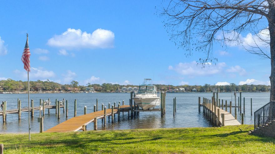 Well renovated townhome with Roof 2022 and HVAC 2020! Enjoy breathtaking views of Boggy Bayou from this beautifully appointed townhome, thoughtfully designed with both style and functionality in mind. The interior showcases upgraded flooring throughout, a well-appointed kitchen featuring stainless steel appliances, quartz countertops with custom edging, and bespoke cabinetry. The main level offers a convenient laundry area with space for full-size machines, a stylish half bath ideal for guests, and a one-car garage. Step outside to the back porch, where you'll find a charming backyard with a beach area and access to a shared dock--perfect for enjoying waterfront living.

Upstairs, the primary suite captures stunning water views and features a private balcony, along with a full bathroom complete with a tiled shower. An additional full bathroom also includes a tiled shower, upgraded vanity, and added storage. Two additional bedrooms provide comfortable accommodations with ample space.

This exceptional property blends refined finishes with serene coastal living. 