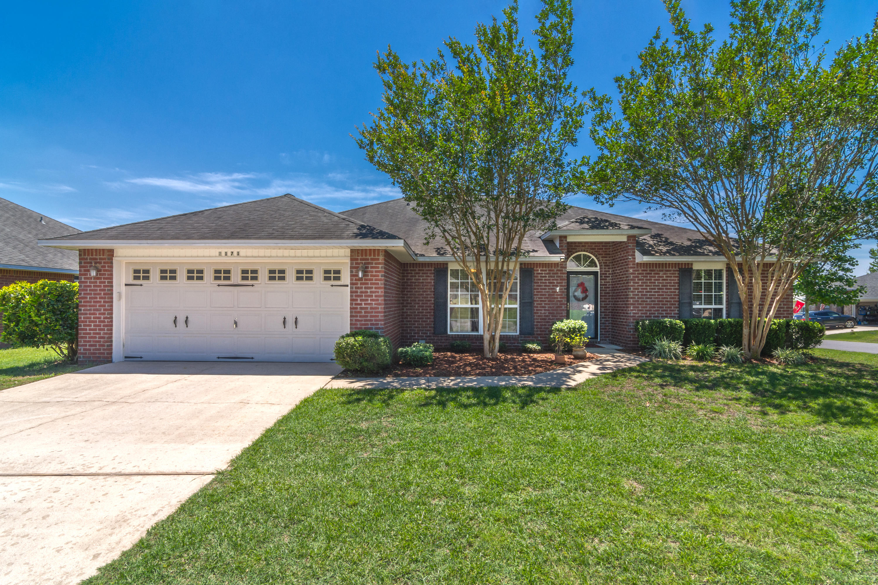 Beautiful 4 bed/2 bath home located on a corner lot in the center of Crestview with easy commute to the local bases, beaches, and shopping centers. Home boasts a large living room, complete with an electric fireplace, that is ready for entertaining family and friends. Kitchen offers ample cabinet space with beautiful granite countertops and a center butcherblock island for all your cooking needs. All appliances convey. Master bedroom is large with a walk in closet and an en suite bathroom hosting a separate tub and shower. Privacy is not an issue as all windows are outfitted with vertical faux wood blinds. Above the 2 car garage is an attic complete with decking for easy storage. The yard is beautifully landscaped with mature trees that provide ample shade during the hot Florida weather,