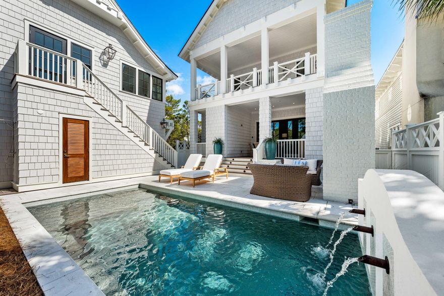 NEW CONSTRUCTION! Embrace a life of casual elegance at this stunning furnished home in the community of WaterSound Beach. Spanning an impressive 4,501 square feet, this stately residence encompasses a 5BR/5.5BA primary home, 1BR/1BA carriage, a 2-car garage, a Gulf view tower, and a private pool with outdoor powder bath and shower.  The home blends coastal sophistication and impeccable design while offering a lifestyle of unmatched comfort and refinement. On the main level, the open-concept kitchen and living area are complemented by a spacious sand room with laundry and a convenient half bath. A junior master suite with an ensuite bathroom featuring dual vanities and a walk-in shower completes this floor. Fine finishes including white oak hardwood floors, custom millwork, quartz countertops, coffered and beamed ceilings, intricate tile work, designer light fixtures, and much more are incorporated into every element in the home design. With an elevator accessing the first three levels, this home offers accessibility along with style and convenience. Step outside through sliding doors from the living room to a large, covered porch where the luxury continues with a summer kitchen, heated pool adorned with water features and sun shelf, an outdoor fireplace, plus a half bath. The inviting outdoor shower is perfect after a day at the beach.
The second floor showcases two exquisite primary suites, each with spa-like ensuite bathrooms, dual vanities, and generous walk-in closets. The main primary suite features a spacious private porch with serene views of the pool and state park, providing a personal oasis within the home. This level also offers a main laundry room, thoughtfully designed with custom cabinetry and sink, as well as an additional guest suite with ensuite bathroom.
Ascend to the third floor for a secondary living area equipped with a beverage center complete with a sink and Sub-Zero refrigeratorperfect for entertaining. A spacious bunk room with double bunks and a full bathroom make this level ideal for hosting family and friends. The crowning fourth-floor tower, with both covered and open spaces, provides breathtaking panoramic views of the Gulf of Mexico, creating a setting for unforgettable sunrises and sunsets. Adding to the allure is a private carriage house, featuring a full kitchen, bedroom, bathroom with dual vanities, living area and a Juliet balcony overlooking the tranquil state park.
The gated WaterSound Beach community is located south of Scenic Highway 30A offering homeowners a rare sense of seclusion yet with easy access to area activities. Amenities include swimming pools, a puttering park, community green spaces, a state-of-the-art fitness center, and private boardwalks to one of the most beautiful mile stretches of coastline in the area. Embrace unparalleled coastal living in WaterSound Beachyour sanctuary awaits!