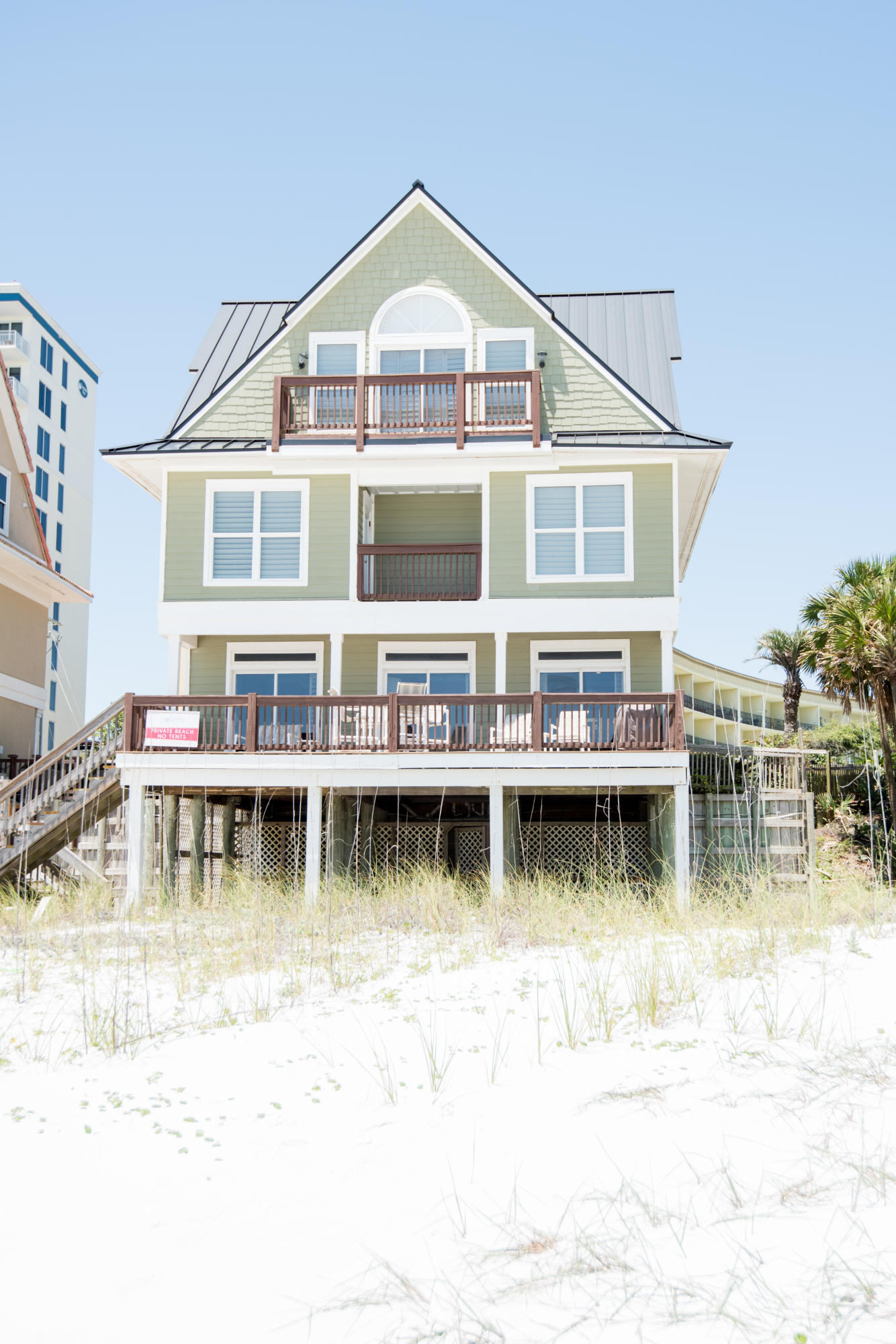 Looking for a gulf front home with breathtaking views, no association fees, and plenty of sand? This home has what your discriminating buyer is looking for. Step through plantation shutters onto hardwood floors to appreciate the decor of this turnkey home. Downstairs is perfect for entertaining with an open floor plan. Two outside decks that are great for relaxing, dolphin watching, and gorgeous sunset views. Bottom deck has electric and water and room for kids to play in the shade.Nice storage underneath the home for all your beach needs.The second floor has two guest rooms with ensuite baths, private balconies, and beautiful views of the beach.The third floor features a large master suite with a sitting area and an office (which could easily be made into a bunk area). This is a MUST SEE!