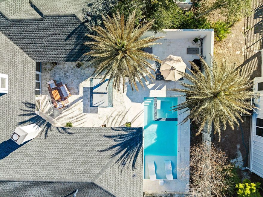 107 Cypress Grove Ln offers a rare combination of privacy, luxury, and convenience in the heart of Seagrove Beach. Tucked away on a quiet street shared by only four other homes, this custom-built residence sits on .23 acres located just off the renowned Scenic Highway 30A, providing easy access to multiple public beach access points, local dining favorites, and Seaside, FL, the epicenter of 30A. Whether used as a full-time residence or a lucrative vacation rental, this home's thoughtful design and location make it an exceptional opportunity. With a proven track record as a high-performing vacation rental, including $272,000 in gross rental revenue in 2023 and $257,000 in 2024, the property is an attractive investment in one of 30A's most sought-after locations. Stepping through the grand stained oak doors, you are welcomed into a beautifully designed home with cypress detailing and a warm, inviting ambiance. The spacious, open-concept living, dining, and kitchen area is designed for seamless indoor-outdoor living, with walls of sliding glass doors that flood the space with natural light and open directly to the expansive private courtyard. The kitchen features a gas range and custom-built pecky cypress vent hood. The primary suite located on the first level serves as a luxurious retreat with direct courtyard access, an updated ensuite bath with a soaking tub, dual vanities, and a large walk-in shower. Two additional guest suites on the first floor each accommodate king-size beds and are joined by a Jack-and-Jill bathroom. Upstairs, the fourth bedroom is a thoughtfully designed bunk room with shiplap walls, a barreled ceiling, and custom twin-over-queen bunk beds. A reading nook with built-in storage, ample play space, and a full bathroom make this level perfect for younger guests or additional sleeping quarters.

The expansive courtyard serves as the heart of the home, offering a beautifully designed outdoor retreat perfect for entertaining and relaxation. Enclosed by an eight-foot-tall concrete privacy wall and framed by mature Sylvester palm trees and native scrub oaks, the outdoor living area possesses a distinct Old Florida appeal. This thoughtfully laid out space includes multiple seating areas, room for dining al fresco, and a cozy outdoor fireplace, creating an ideal setting for gatherings. A heated saltwater pool and spa, newly added in 2022, and new pool deck complete the outdoor experience, making it a perfect place to unwind and enjoy the Florida lifestyle.

Adding to the home's versatility, a fully equipped one-bedroom attached guest house with a private entrance, kitchen, and living space offers an excellent opportunity for rental income or extended guest stays. The guest house also features its own private outdoor space with a hot tub and could be rented separately or together with the main house, providing flexibility for investment potential.

In addition to the .23-acre lot the home sits on, the adjacent .07-acre deeded lot provides an incredible opportunity to expand the home's livable space or enhance the outdoor area with features such as a carriage house, sport court, or additional lounging and dining space.

Set within a non-HOA neighborhood, the home offers the perfect balance of privacy and accessibility. While the white sand beaches along the Gulf are just minutes away, nature lovers will also appreciate the proximity to the trailhead leading into Point Washington Forest, where miles of scenic trails and a winding boardwalk through a picturesque cypress pond provide a tranquil retreat.

With its prime location, stunning design, and exceptional rental history, 107 Cypress Grove Ln presents a rare opportunity to own a distinctive coastal home that perfectly blends luxury, comfort, and investment potential.