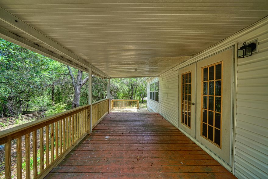 South Crestview off PJ adams, this adorable 3 bedroom, 2 bath double wide sits on almost 2 acres! Home is very private and secluded with a long wooded driveway and woods on all sides! New roof, new deck, and new touches inside make this home both affordable and ready for new owners. 2 sheds, and an oversized deck will make you want to stay in and enjoy the quiet.